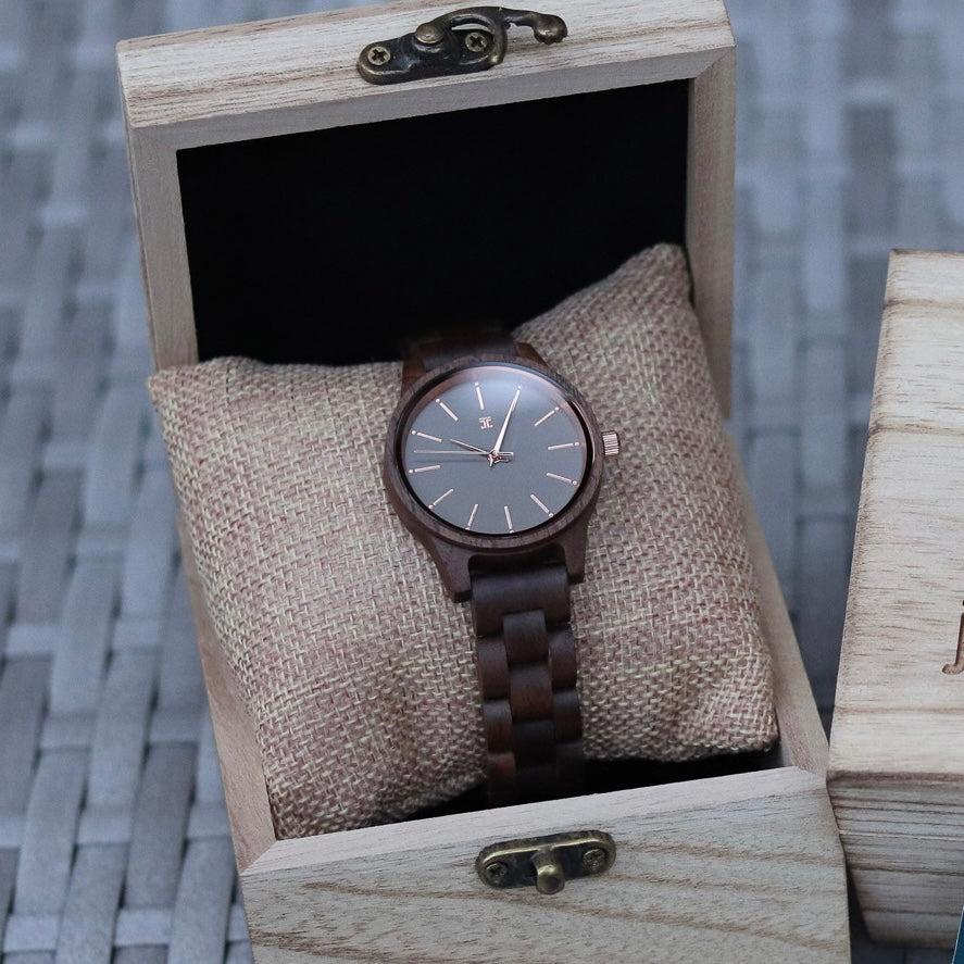 Round wooden watch with dark brown band and gray dial in a wooden display box