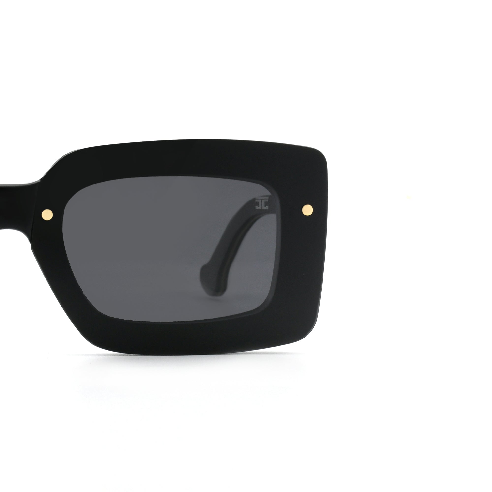 Close-up of the side of Joycoast black wooden square sunglasses showing the dark lens, frame and two gold accent.