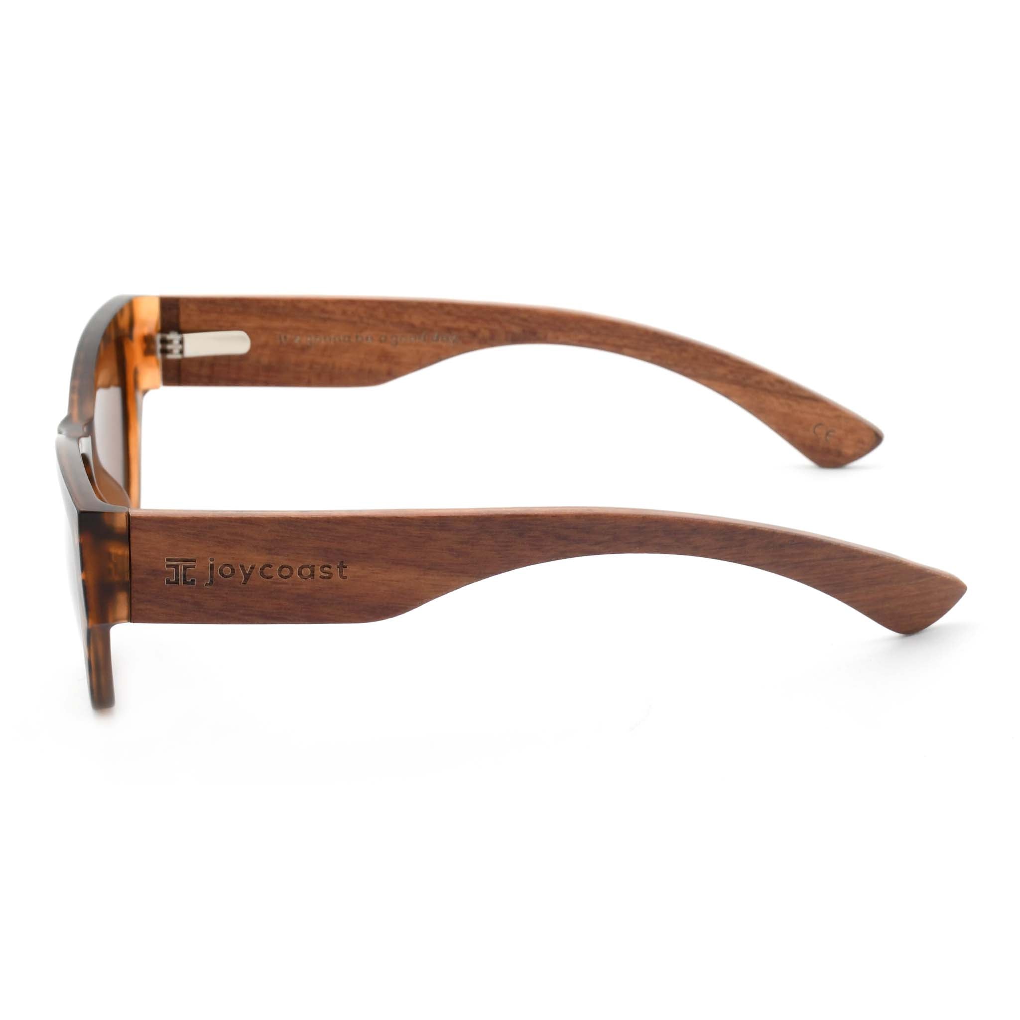Joycoast Juniper wooden sunglasses with an engraved "Joycoast" logo, viewed from a top-down perspective on a white background.