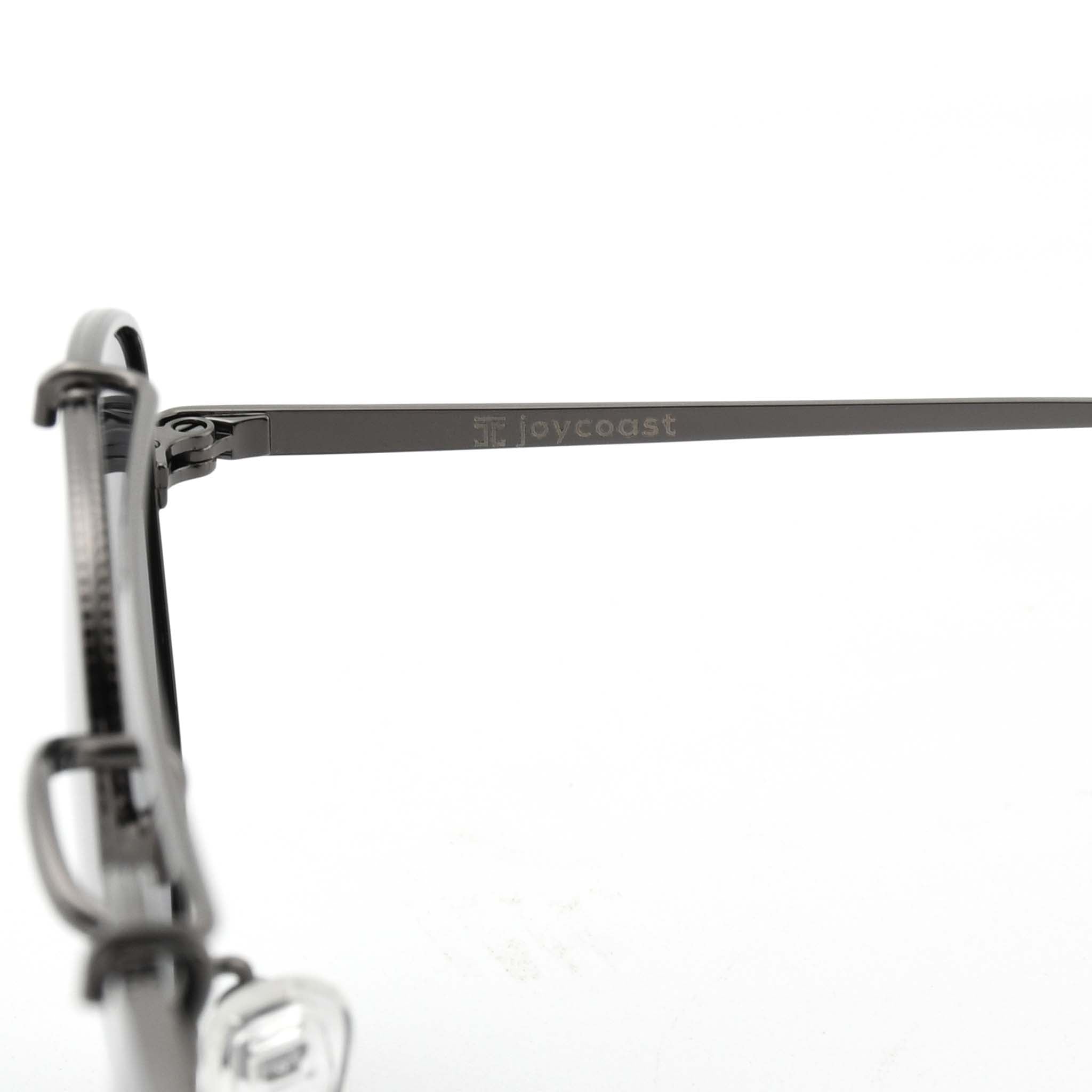 Close-up of the black metal arm of Joycoast Skyline sunglasses with "Joycoast" engraved near the hinge.