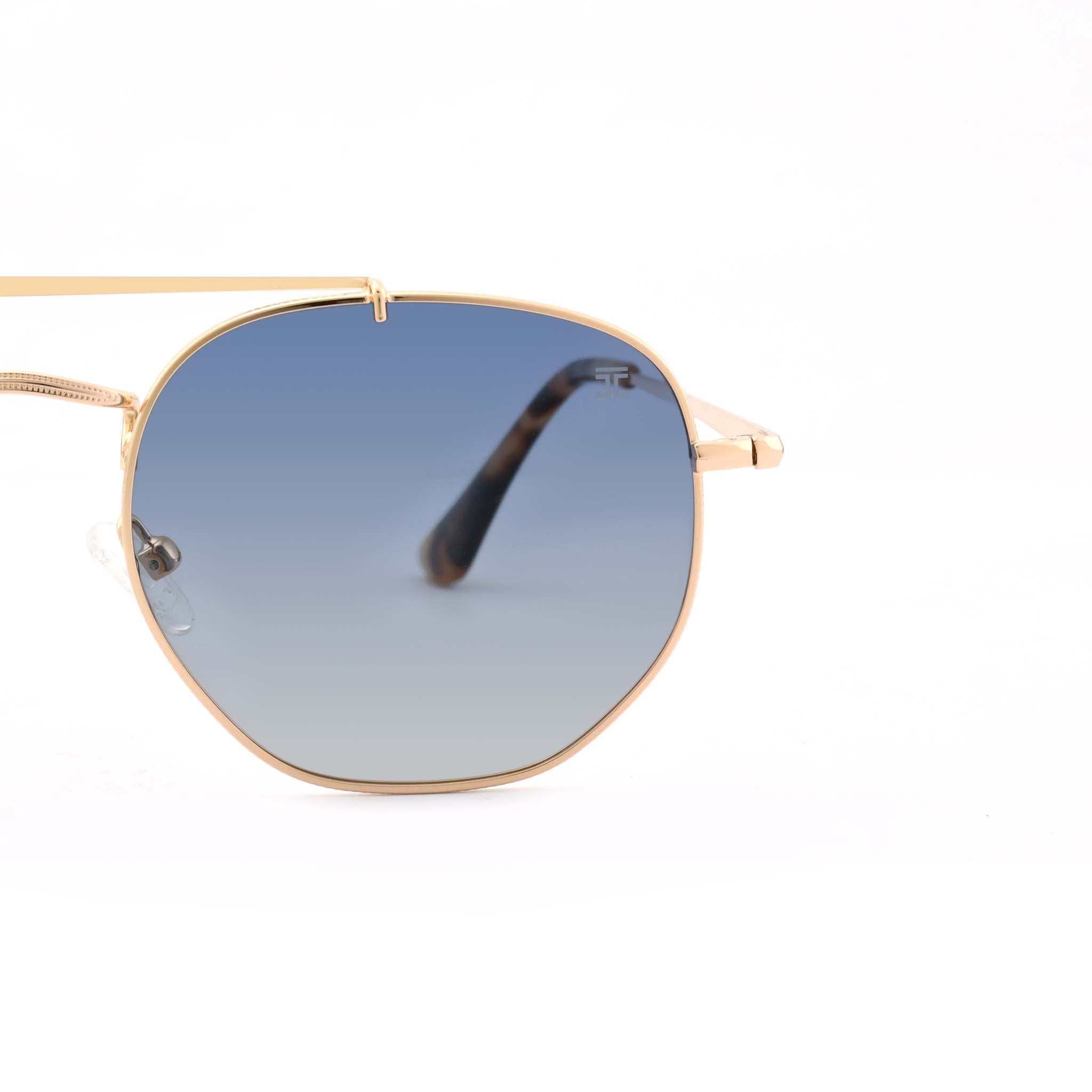 Partial view of Joycoast Skyline gold metal sunglasses showing the light blue gradient lens and a tortoise shell arm.