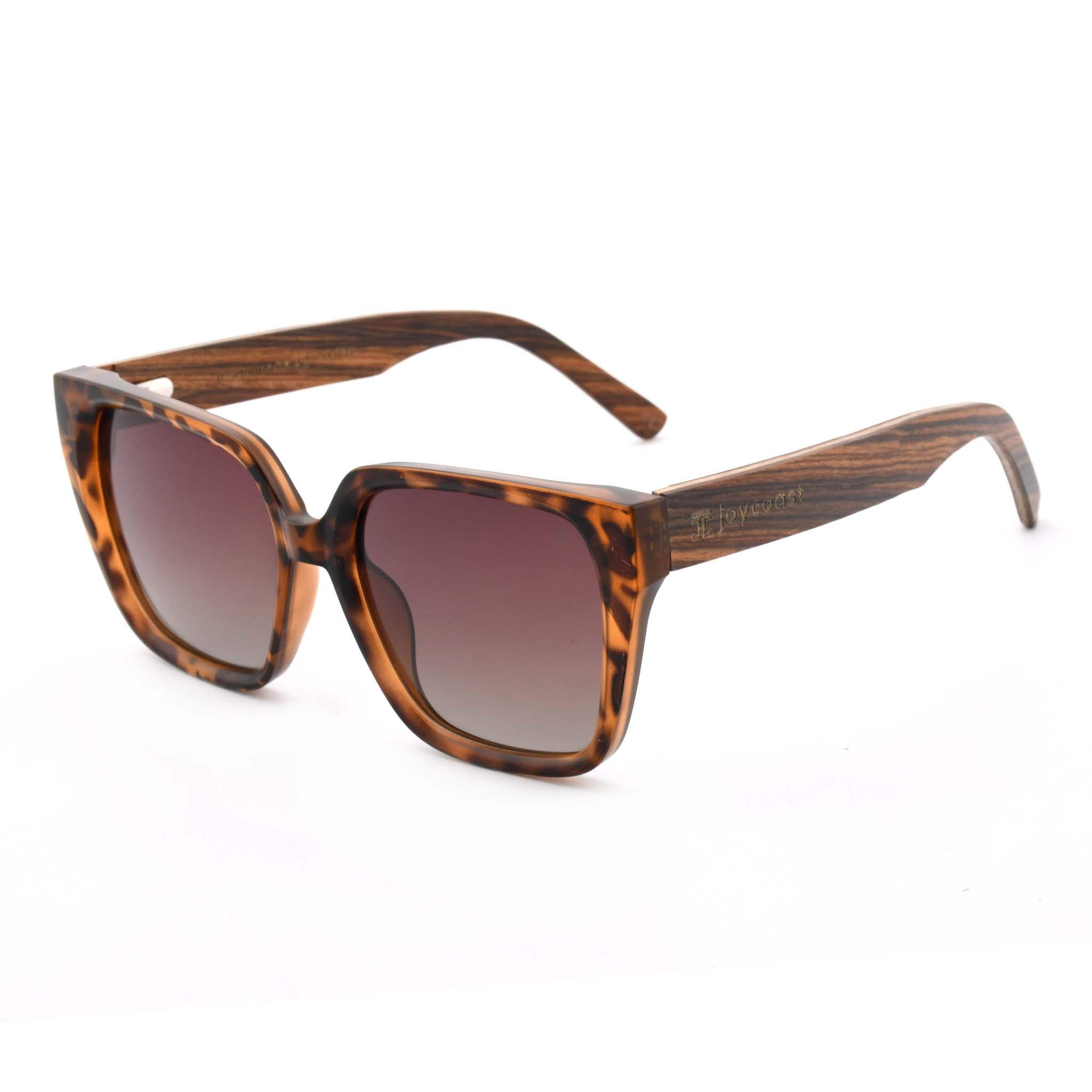 Sunglasses with tortoiseshell frame and brown gradient lenses on a white background