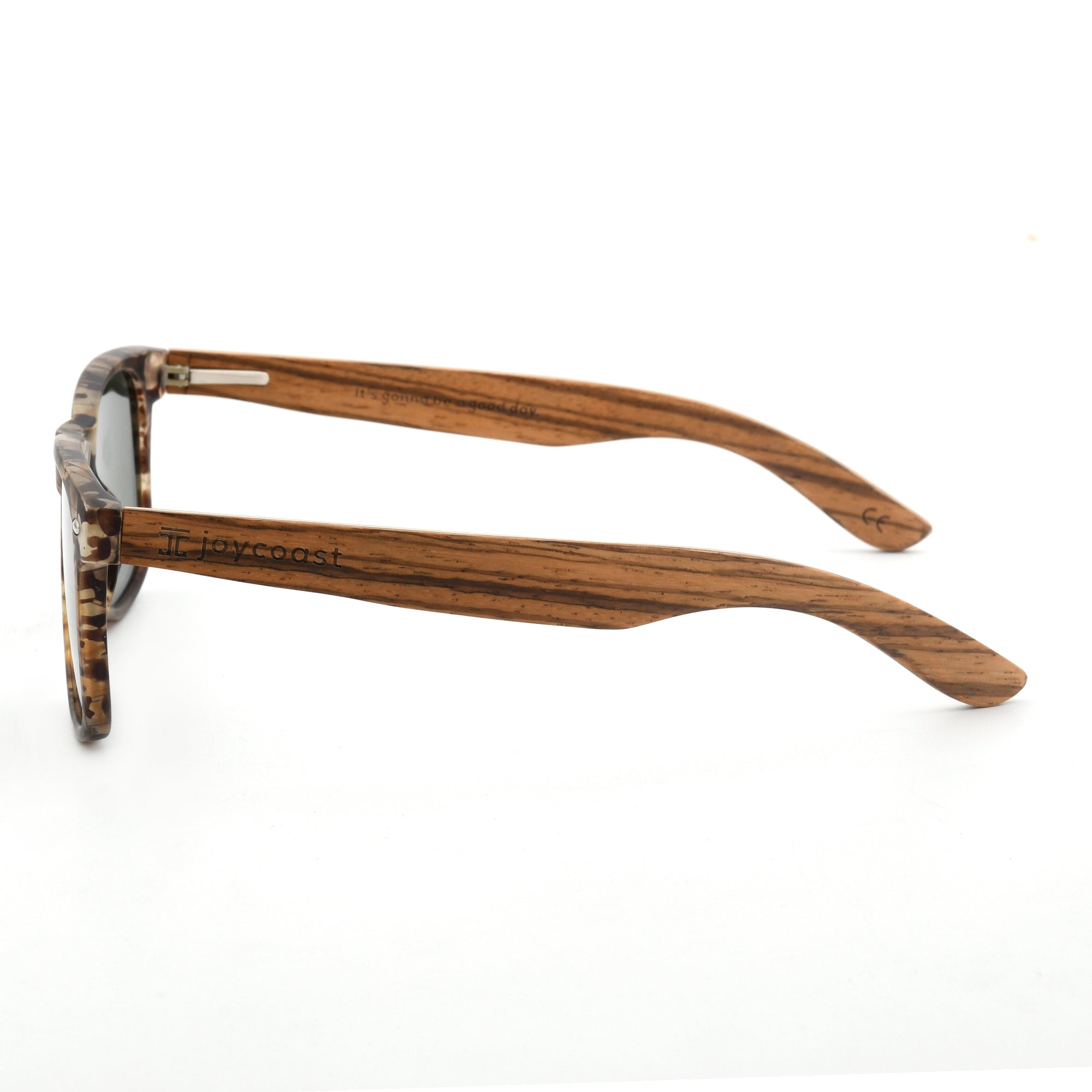 Joycoast tortoise shell wooden sunglasses with dark lenses and wooden arms, viewed from a top-down perspective on a white background.