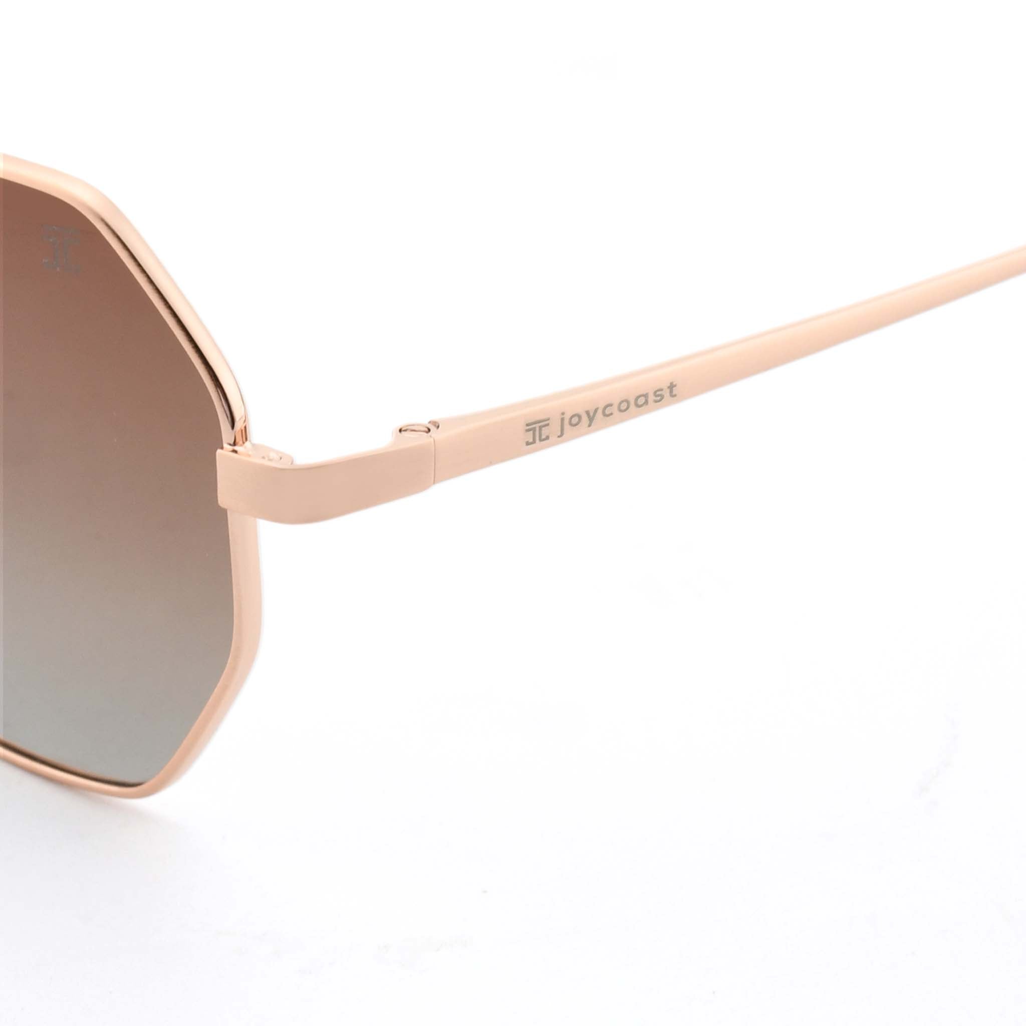 Close-up of the rose gold metal arm of Joycoast Vesuvio sunglasses, with "Joycoast" engraved and a brown gradient lens visible.