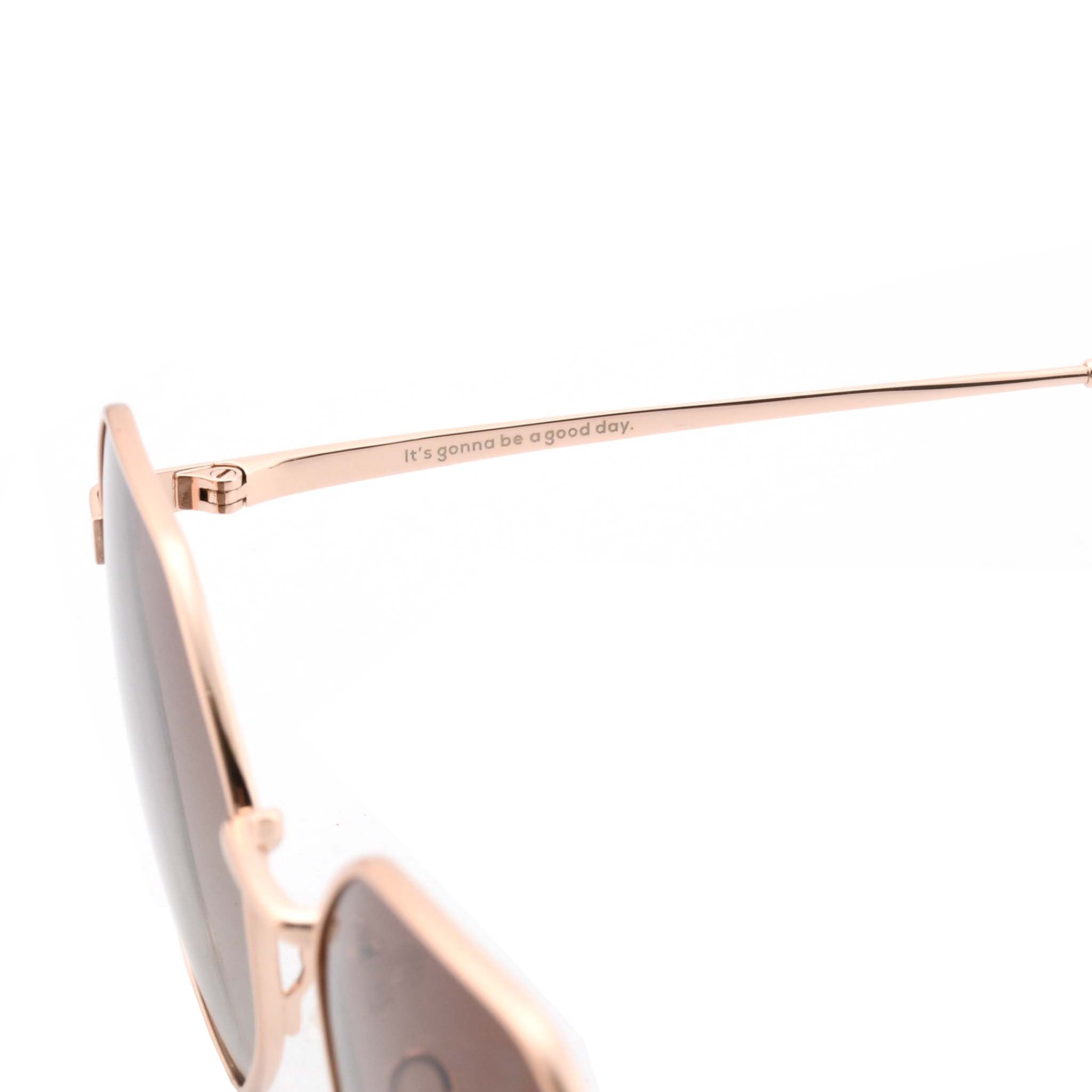 Close-up of the rose gold metal arm of Joycoast Vesuvio sunglasses, with the slogan "It's gonna be a good day." engraved.