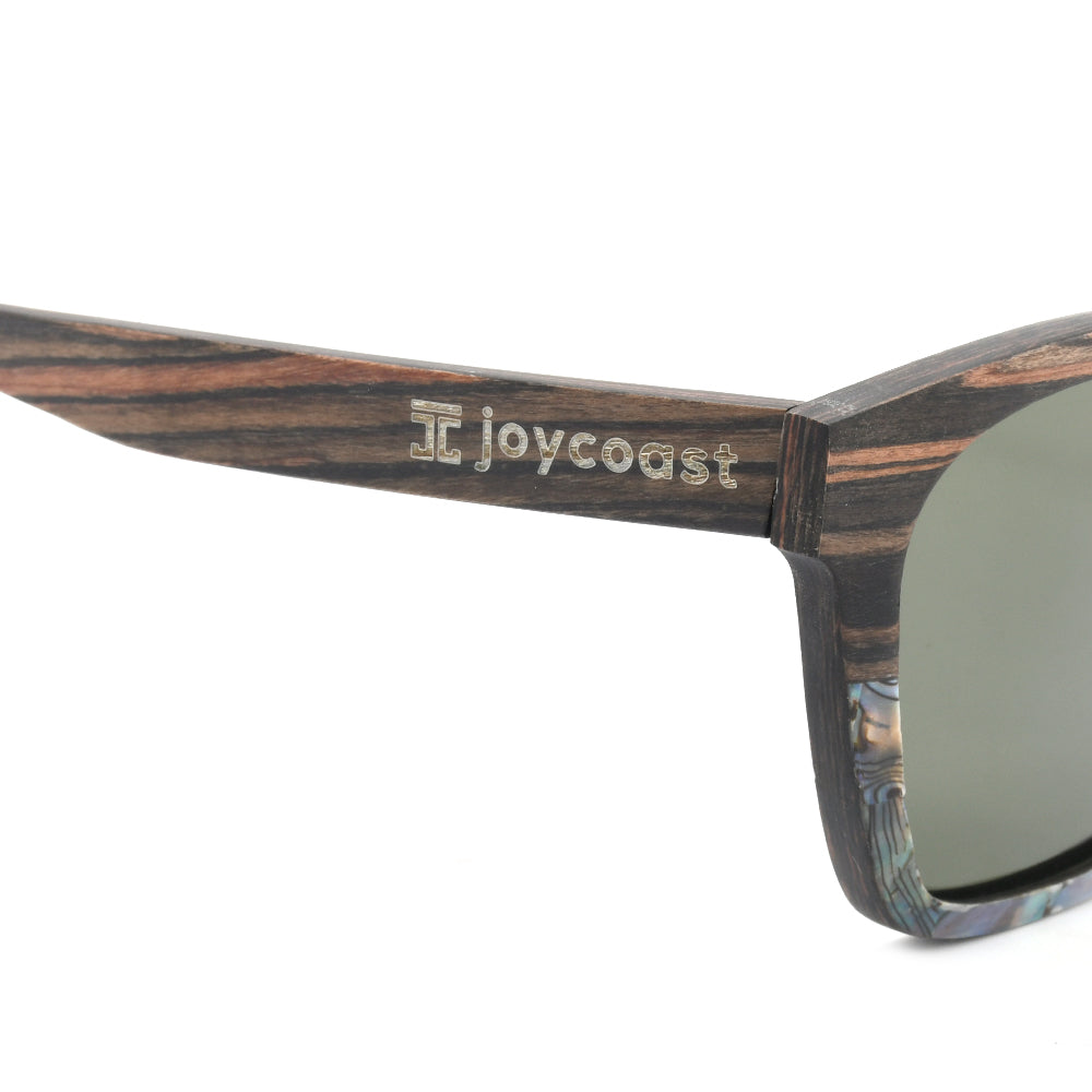 Wooden sunglasses temple with Joycoast logo and dark patterned frame