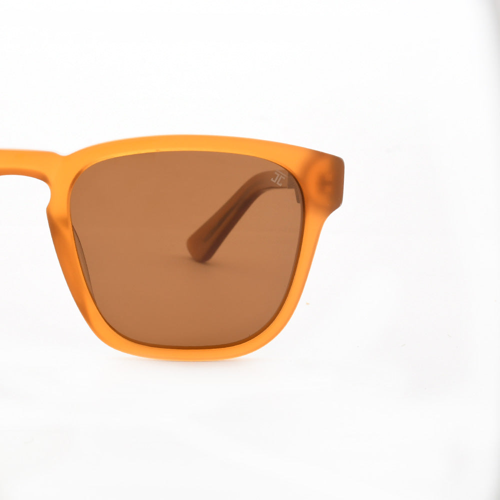Orange sunglasses with brown lens close-up and angular frame shape
