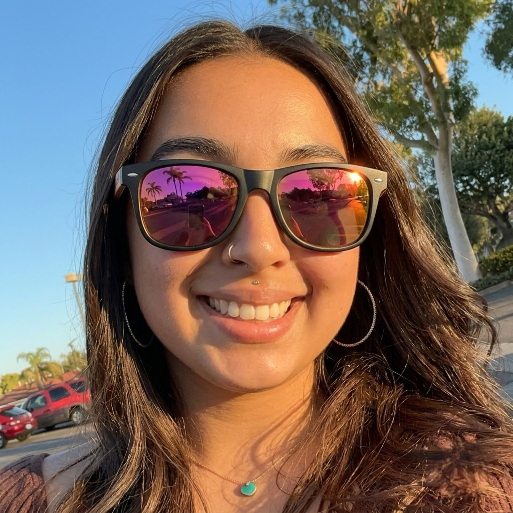 Person wearing black wayfarer sunglasses with pink mirrored lenses and wood temples