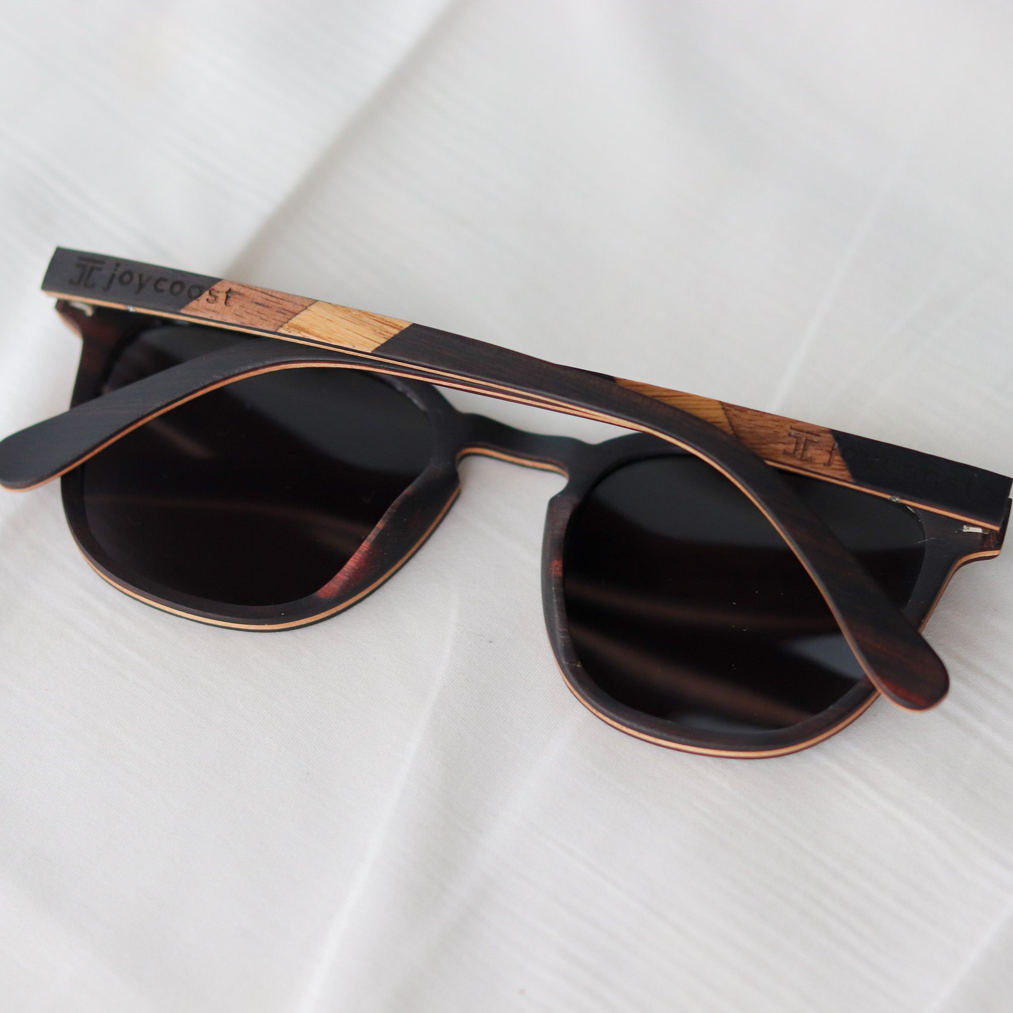 Ebony wooden sunglasses, side angle with black lenses and wood-pattern temple