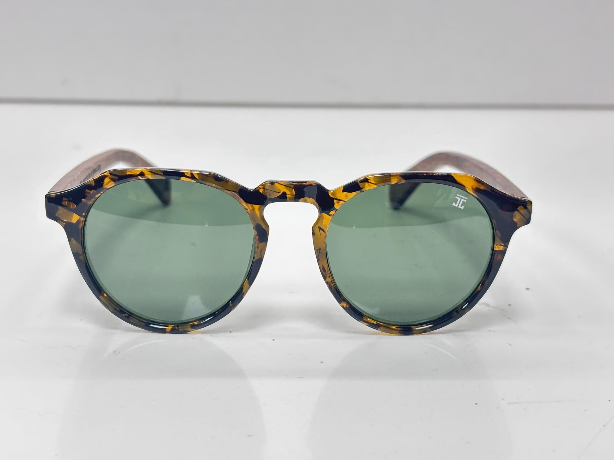 Joycoast tortoise shell round sunglasses with green lenses.
