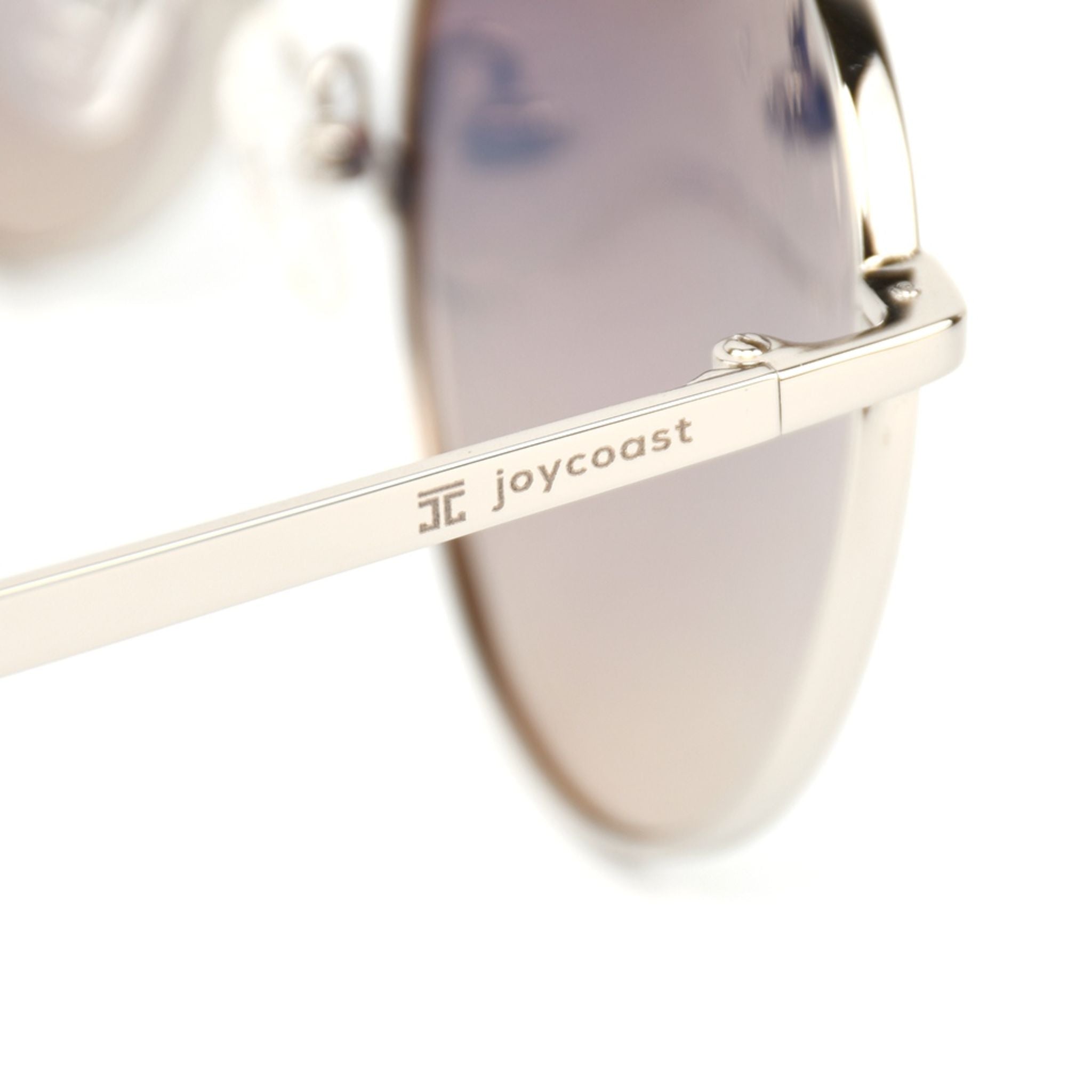 Cat-eye sunglasses arm with joycoast logo and tinted gradient lens