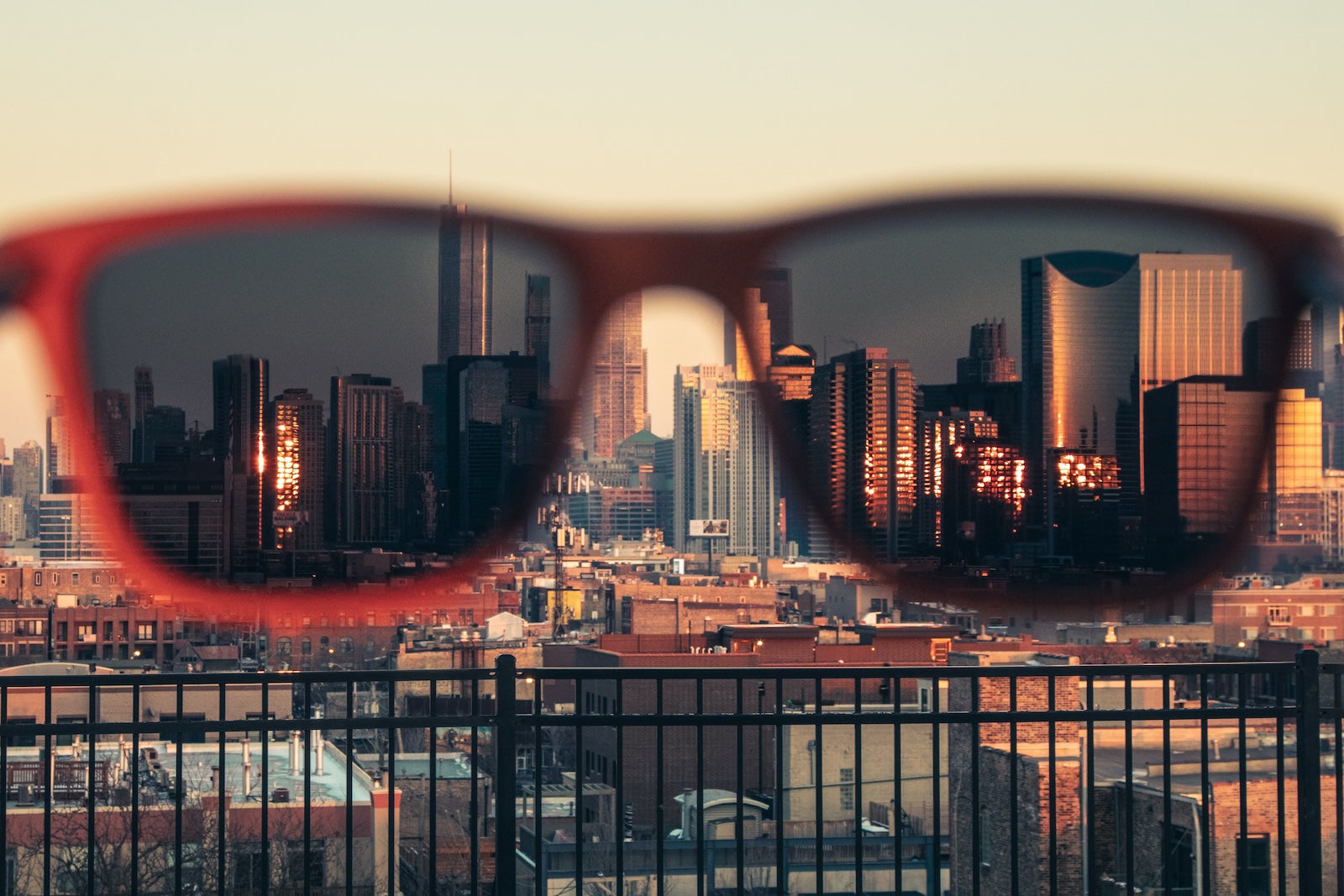 Joycoast wooden sunglasses holding over the city view of Chicago