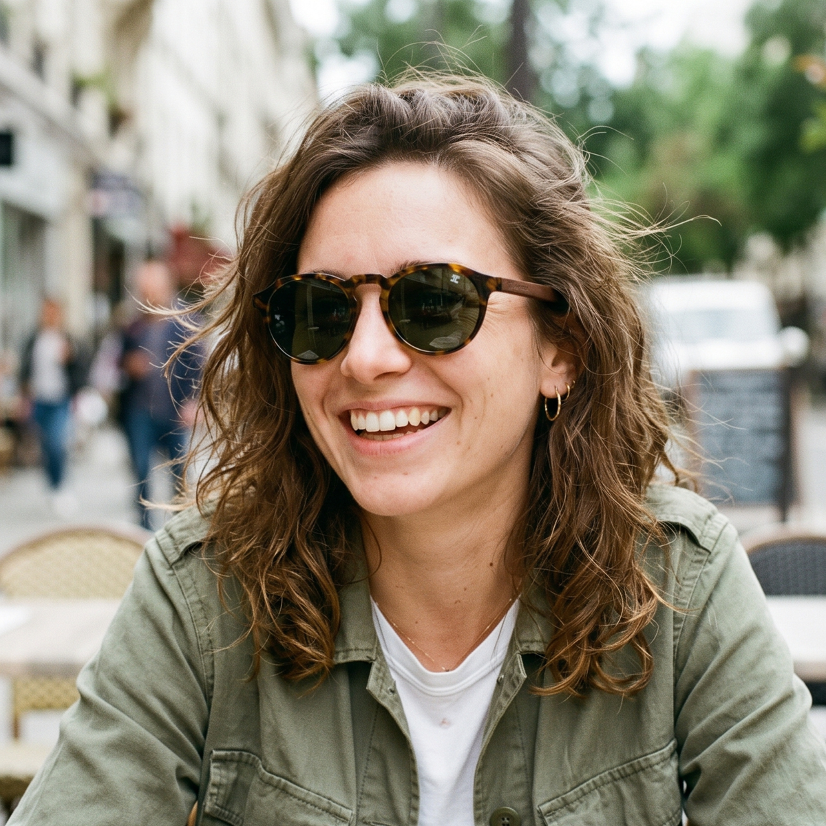 Round tortoiseshell wooden sunglasses on person with green lenses