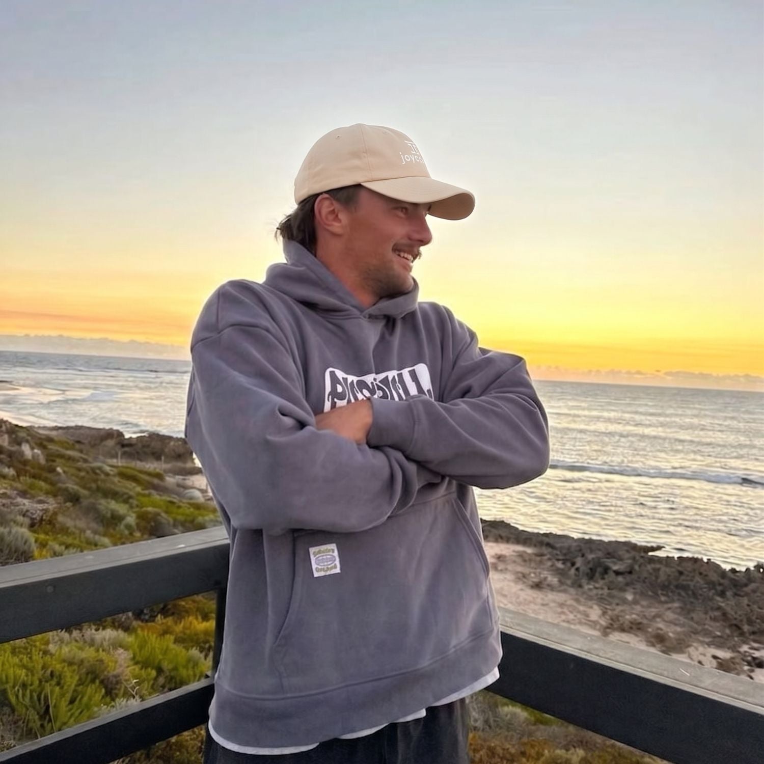 Joycoast cream baseball cap worn by a person outdoors