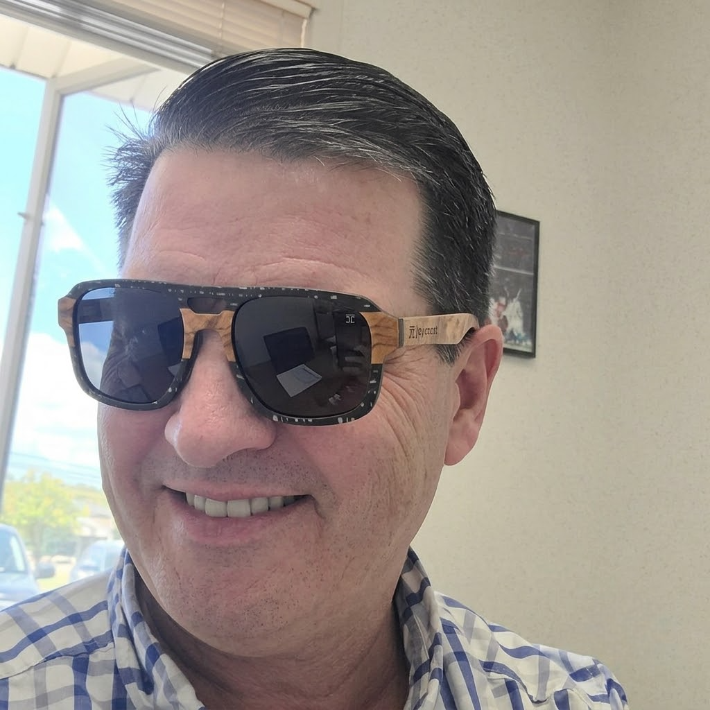Ebony wood aviator sunglasses worn by a person, dark lenses with wood frame.