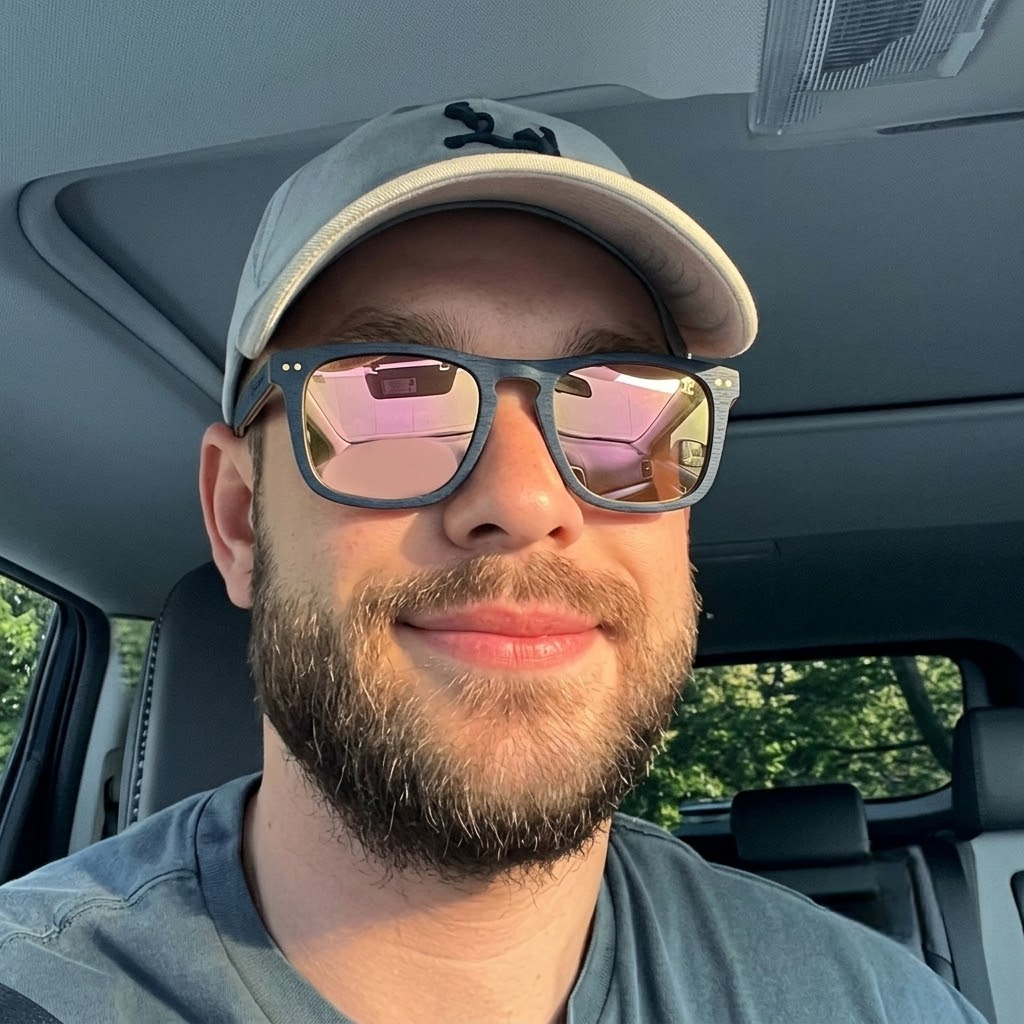 Maple wood sunglasses worn by a man, blue frame with pink mirrored lenses