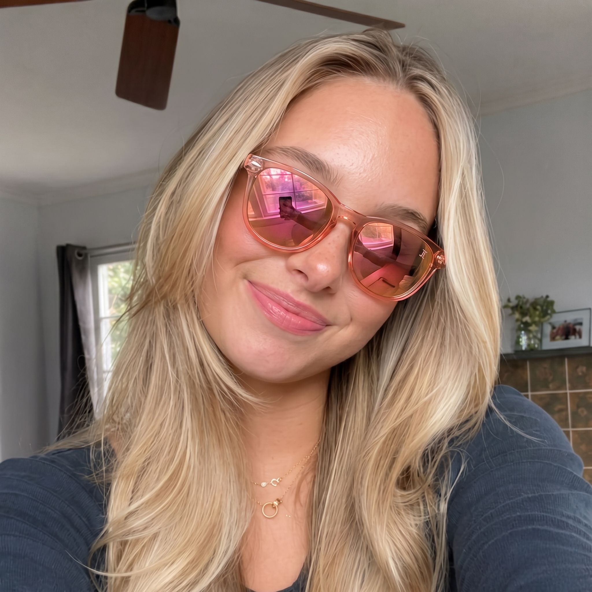 Pink mirrored wooden sunglasses with clear frame and wood temples, close-up