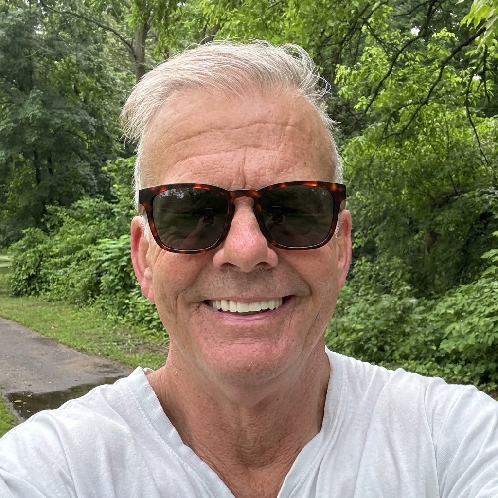 Wood and tortoiseshell sunglasses on a smiling person, dark lenses, close-up