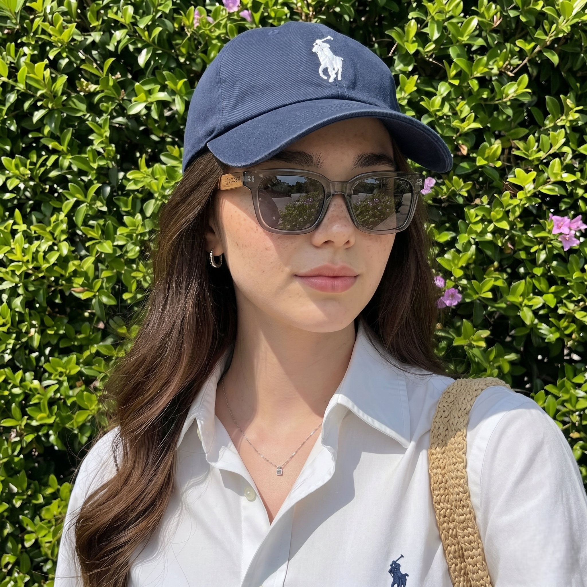 Wood temple sunglasses with dark lenses and a rectangular charcoal frame on a model