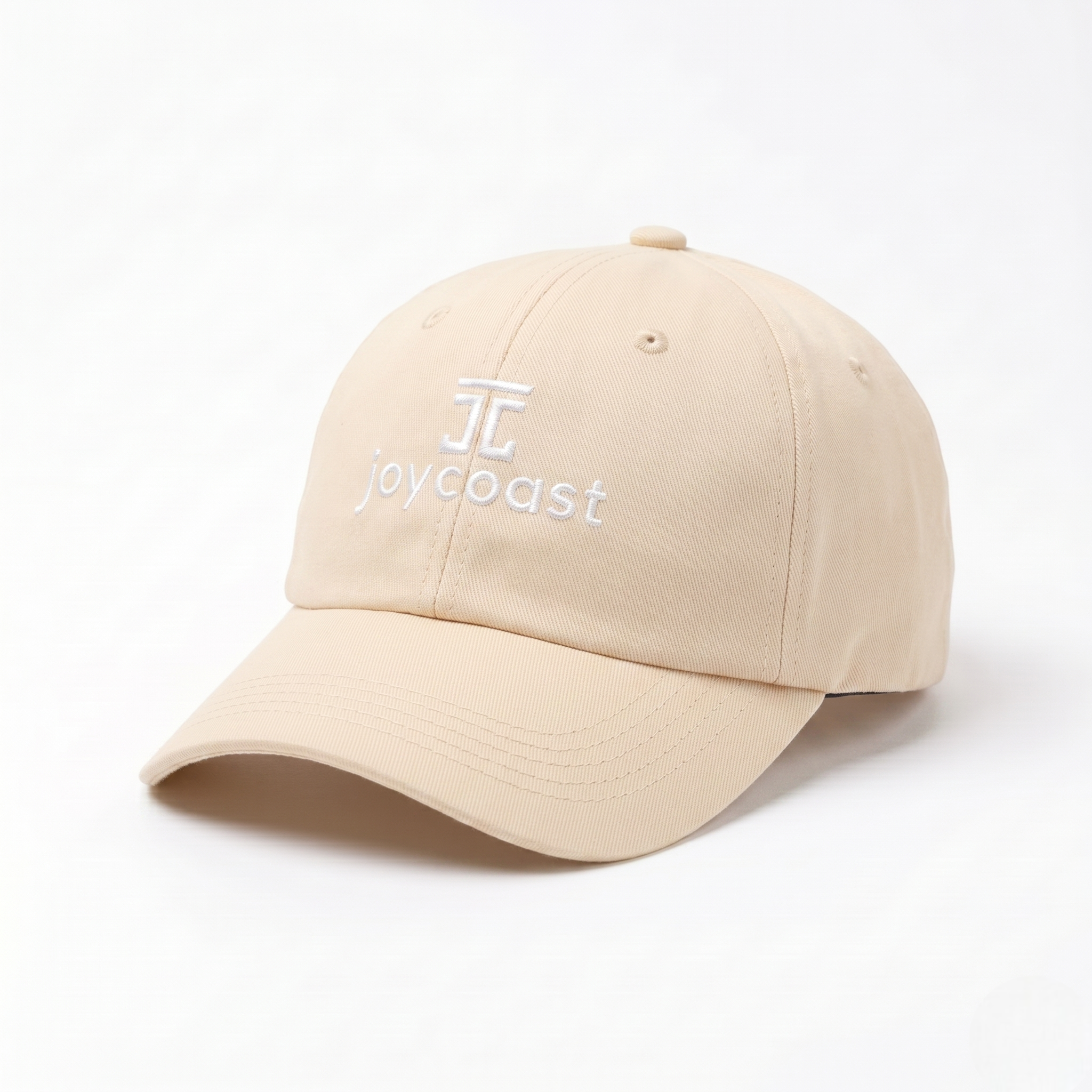 Cream Joycoast baseball cap with embroidered logo on front panel