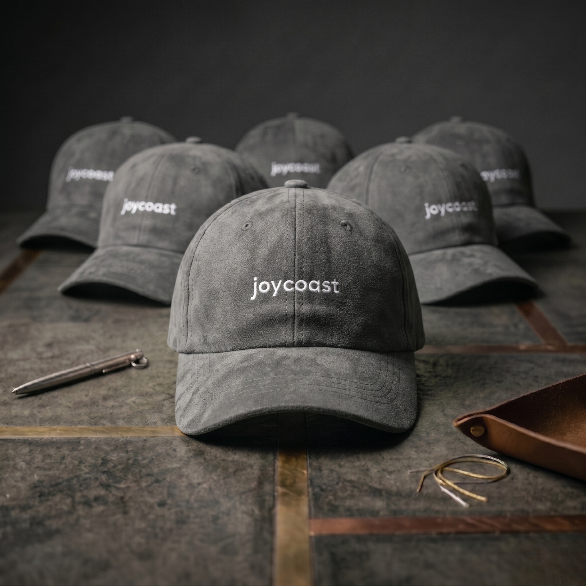 Grey Joycoast baseball cap, front view, curved brim and joycoast logo