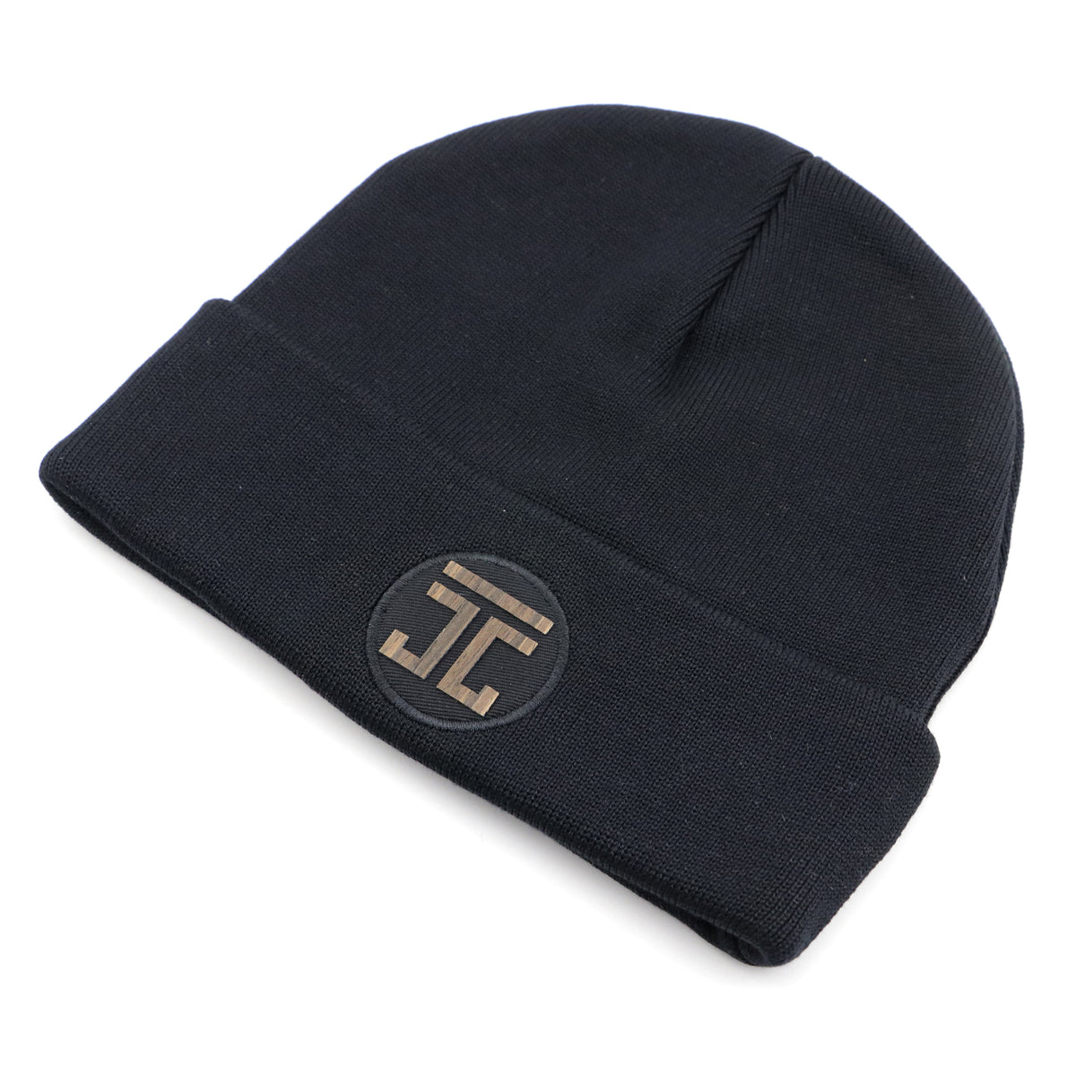 Dark knit beanie with circular logo patch on the cuff