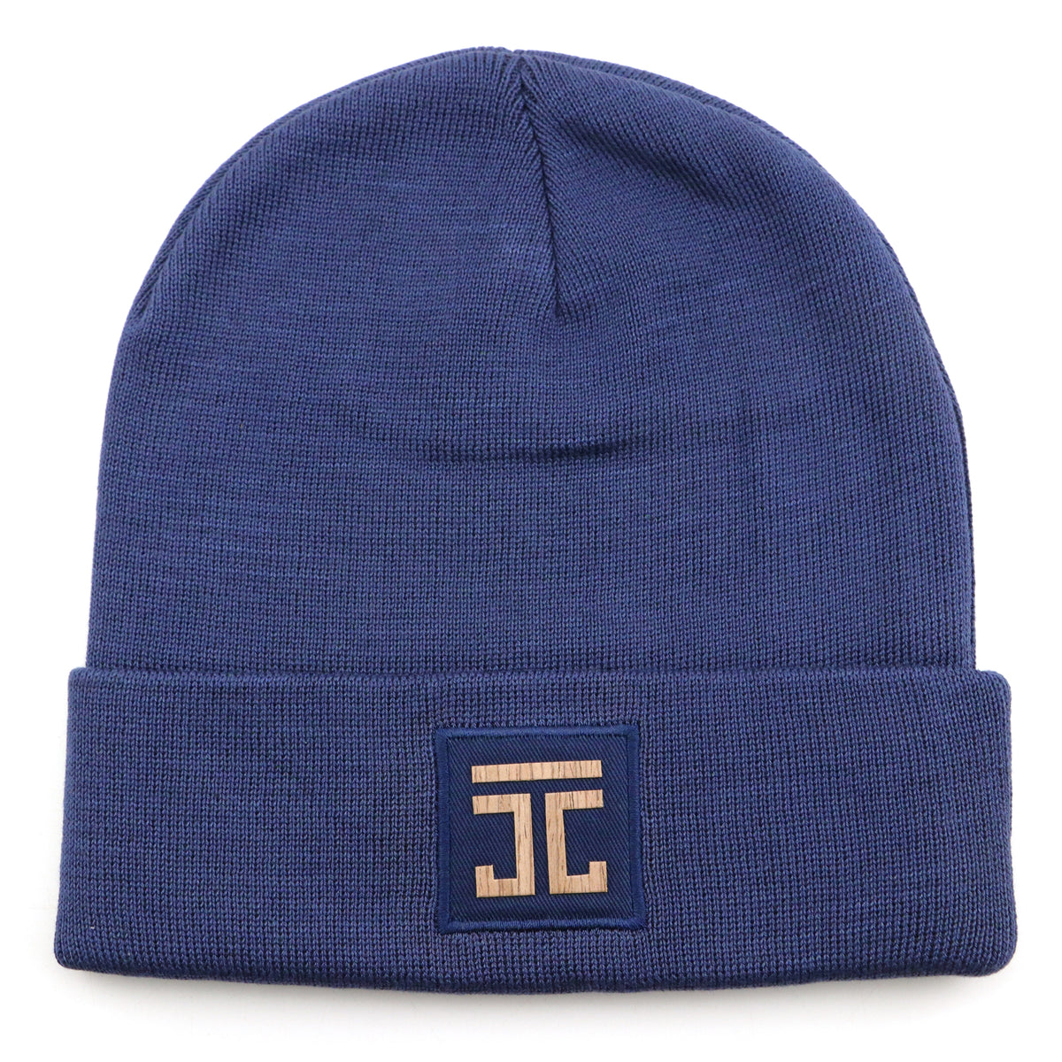 Blue knit beanie with square logo patch at the front cuff