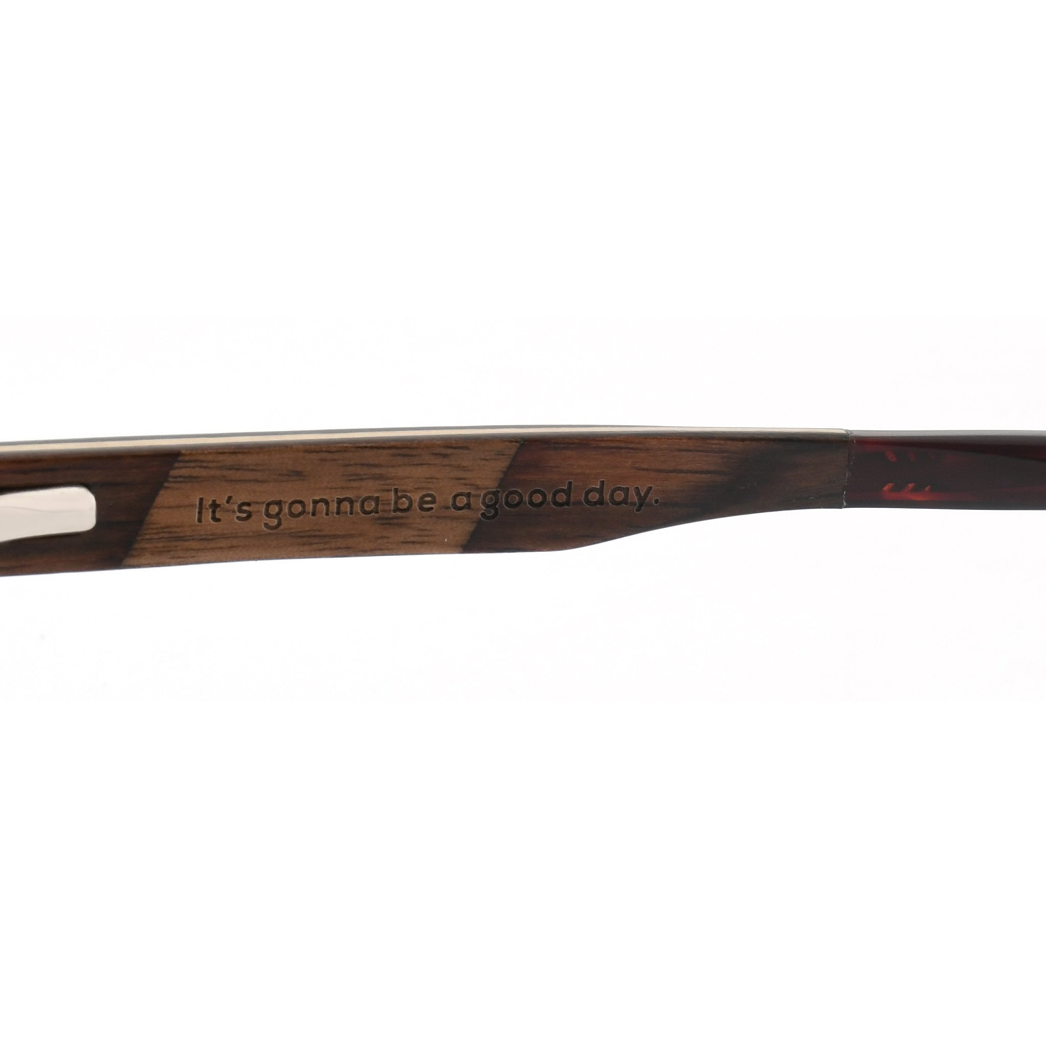 Wooden reading glasses side temple with printed slogan and clear lens cutout.