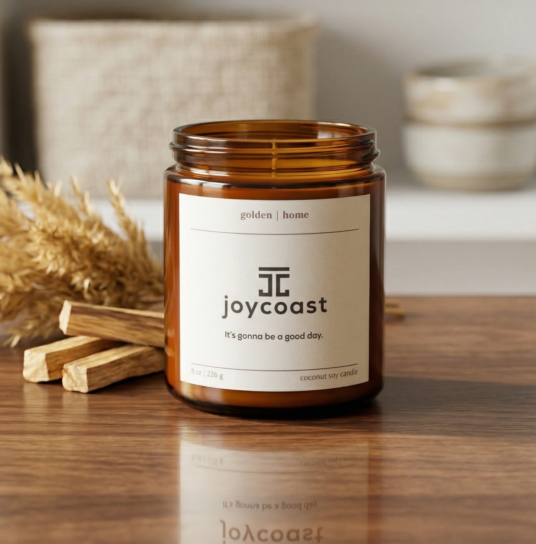 Joycoast candle on a wooden surface with decorative elements