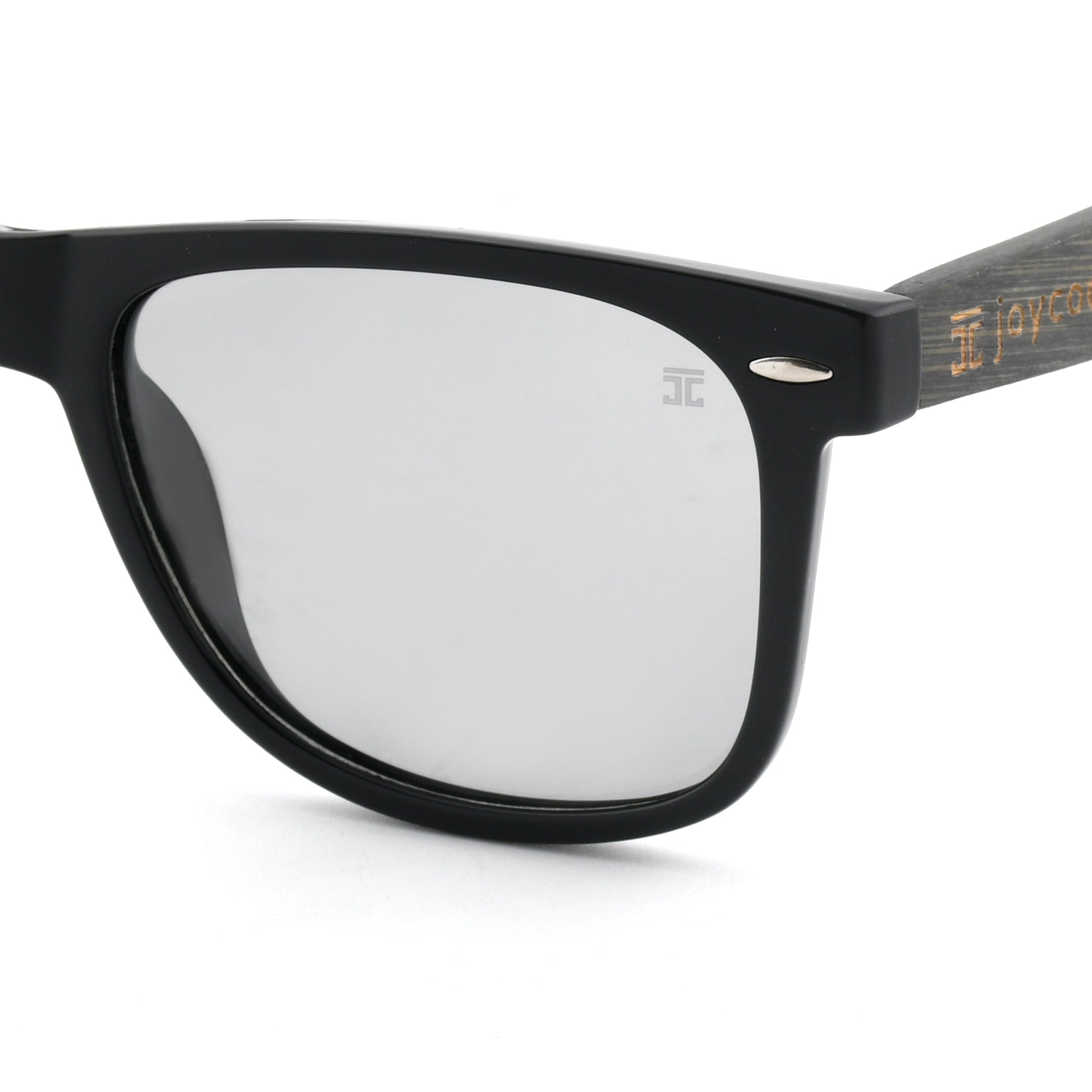Partial view of Joycoast black wooden eyeglasses with clear lenses and wooden arms.