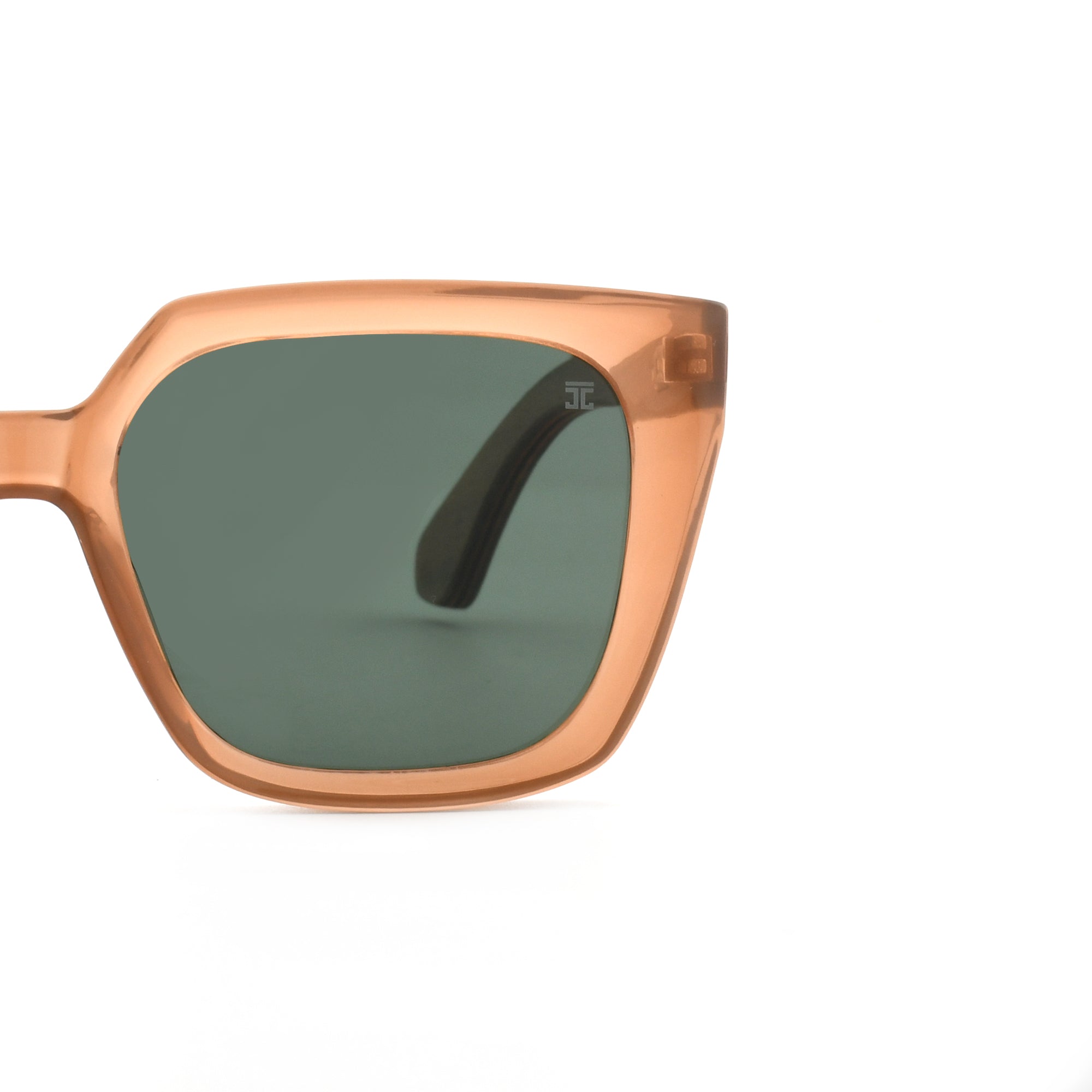 Partial view of brown square sunglasses with dark green lenses and a dark arm.
