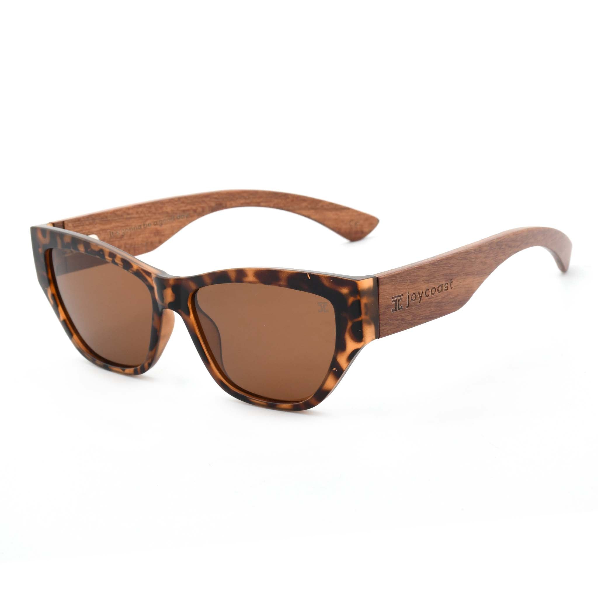 Joycoast Juniper tortoise shell sunglasses with brown lenses and wooden arms, viewed from an angle on a white background.