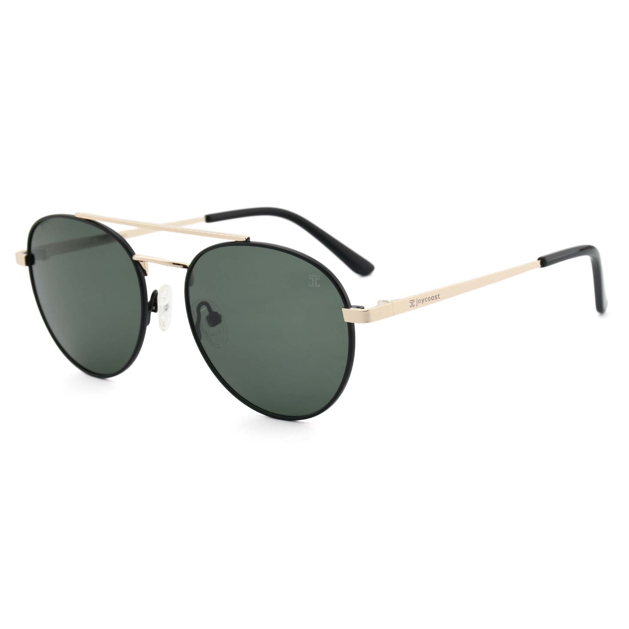 Joycoast Willow round gold sunglasses with dark green lenses and a thin black arm, viewed from an angle on a white background.