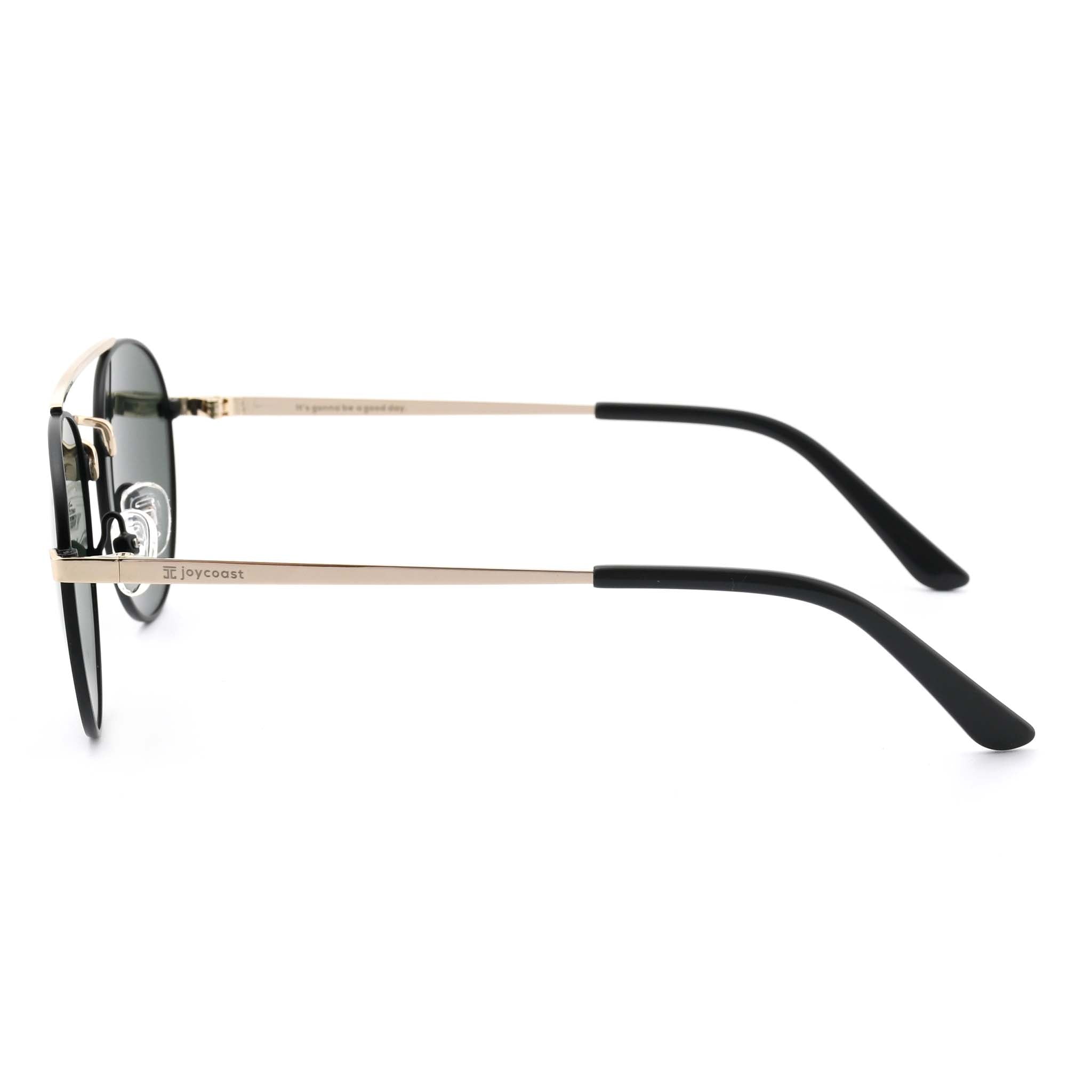 Joycoast Willow round sunglasses with gold metal frames and black arms, viewed from the top down on a white background.