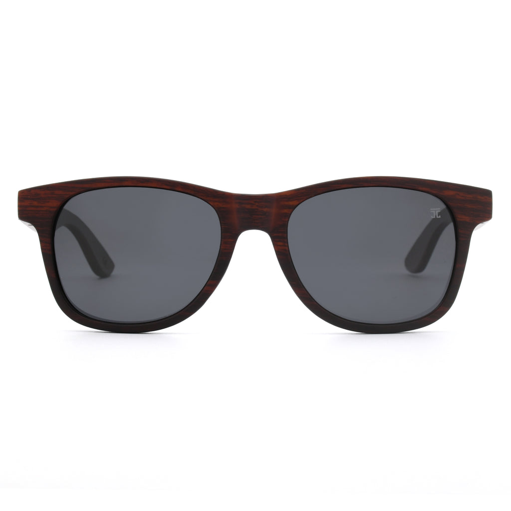 Wood sunglasses front view with two dark lenses, brown wood bridge and black edging