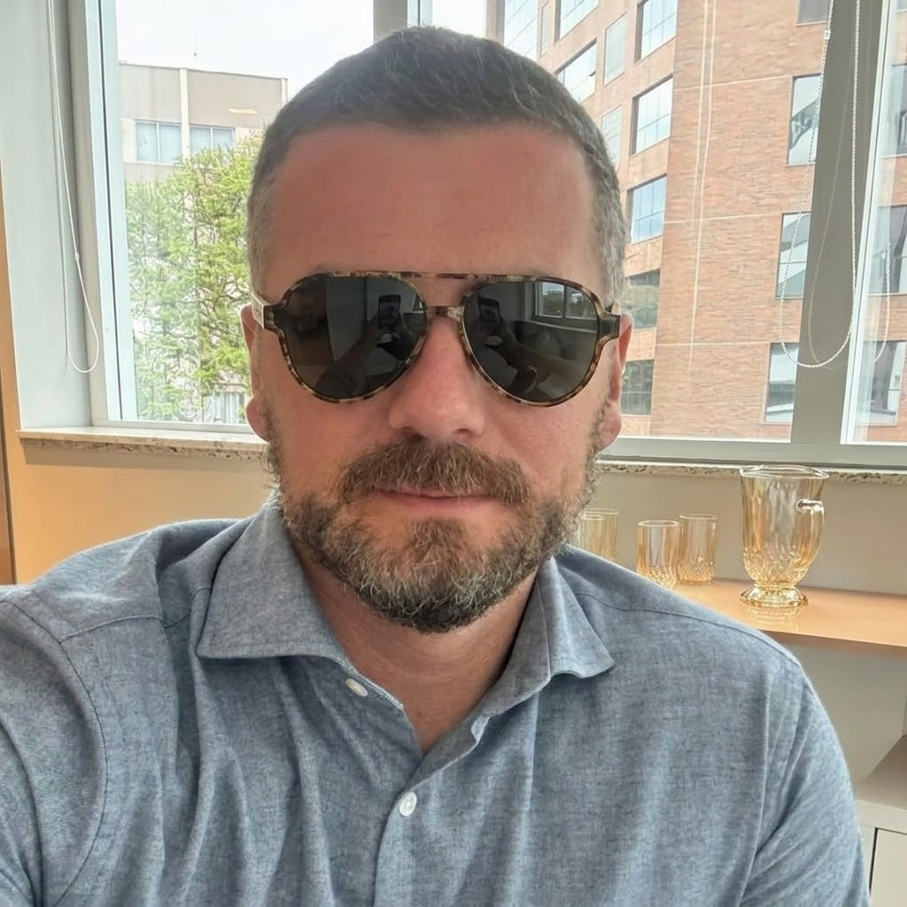 Amber tortoise wooden sunglasses with dark tinted lenses on a man