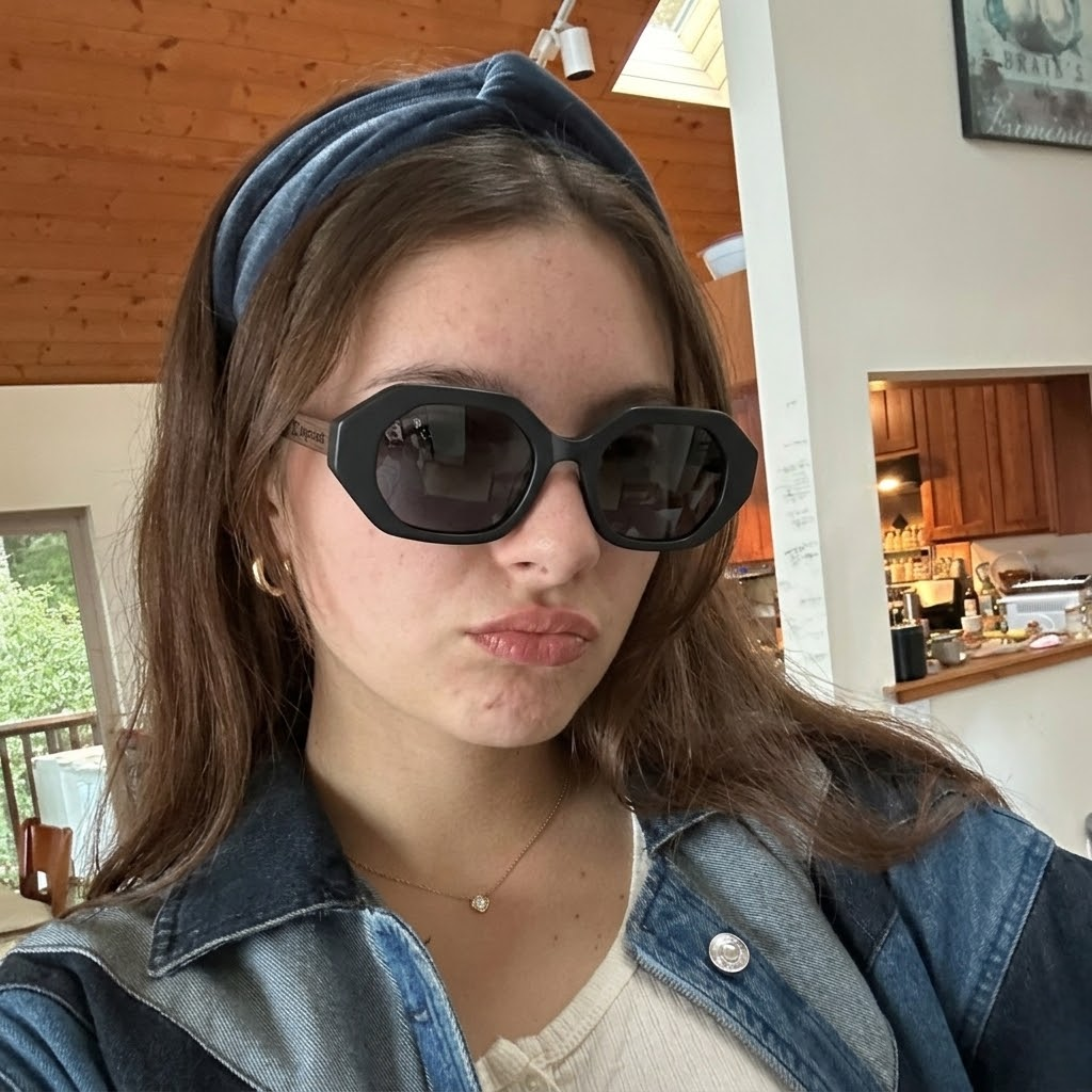 Black acetate sunglasses with oversized rounded lenses and gold-toned logo detail