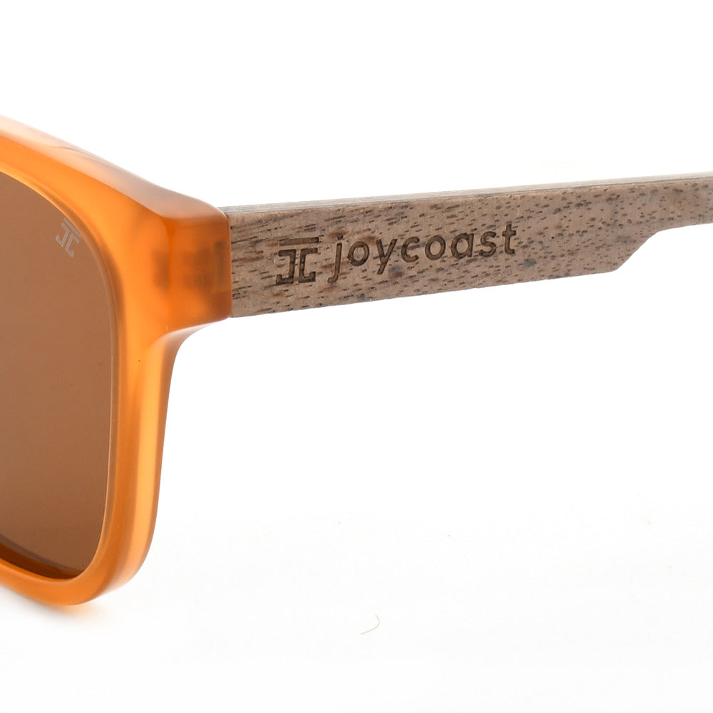 Orange sunglasses with wooden temple arm and joycoast logo engraving