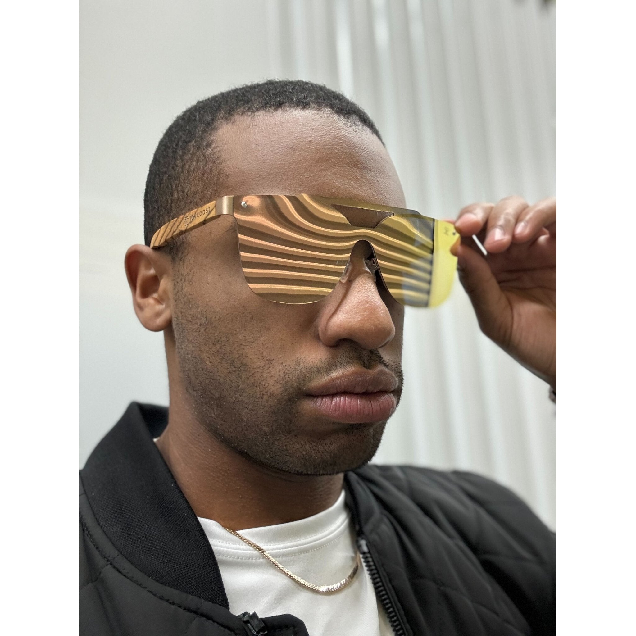Frameless sunglasses with gold reflective lenses and metal temples