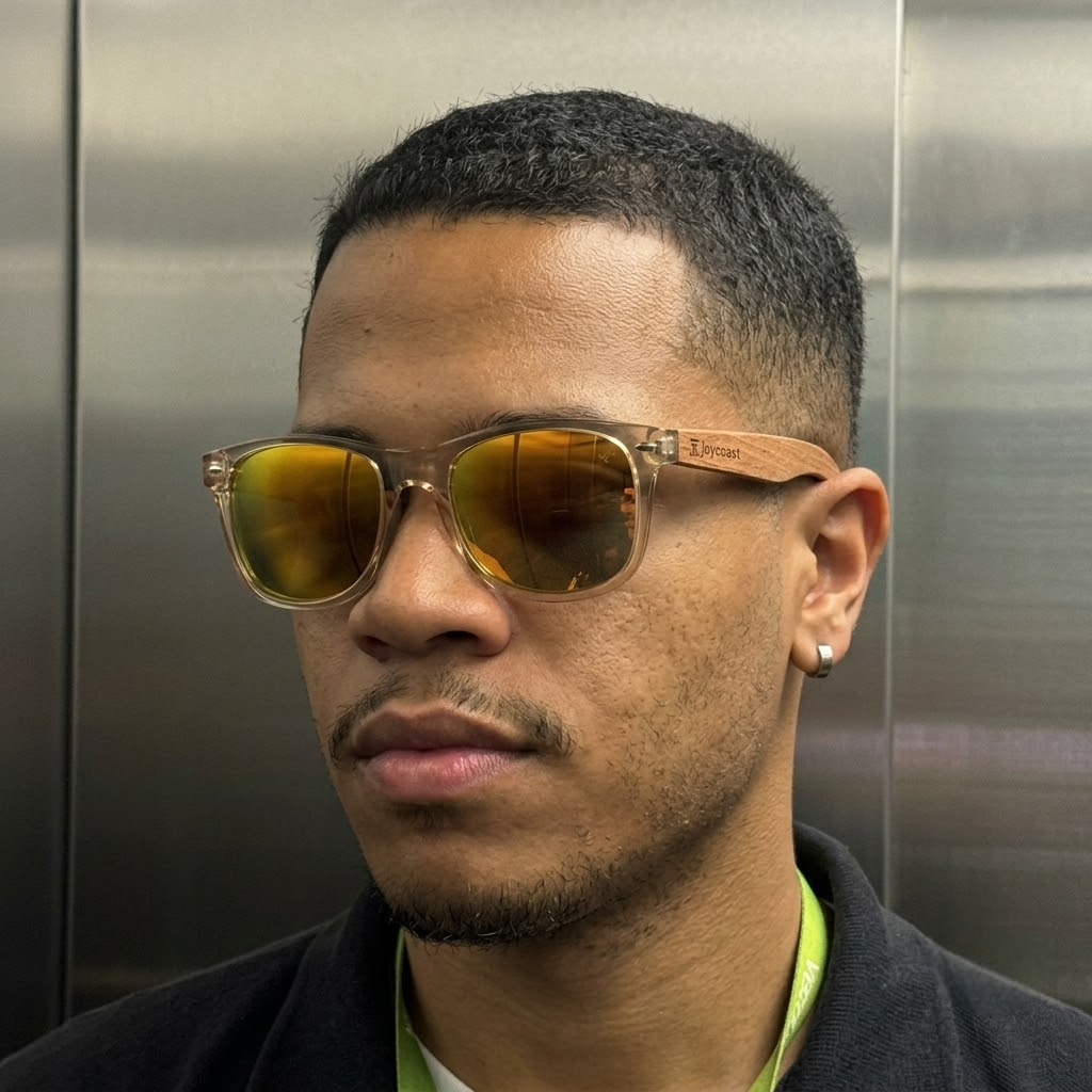 Wood and metal sunglasses with yellow lenses on a man's face, side angle