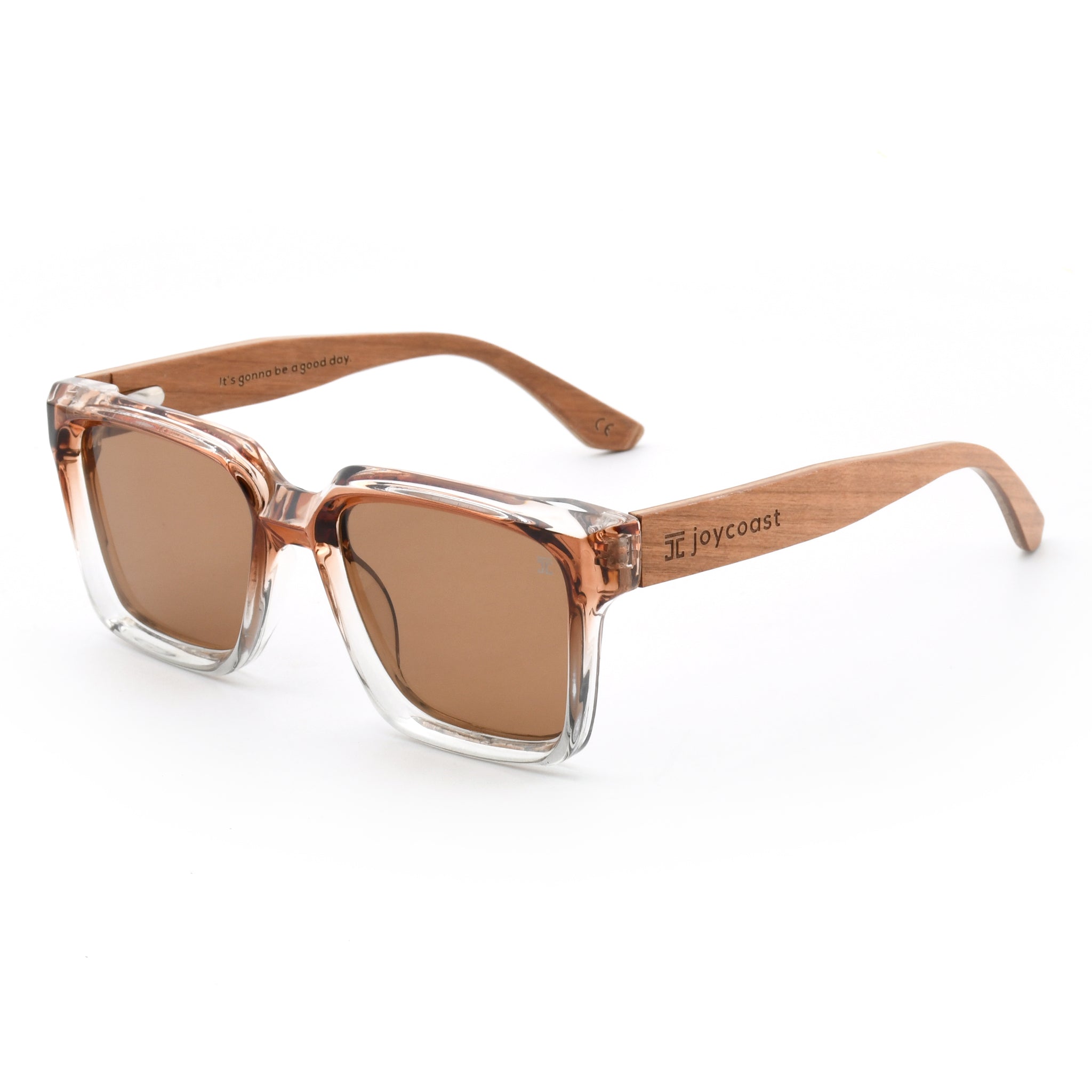 Oversized sunglasses with transparent rose frame, brown lenses, and light brown wood temples.