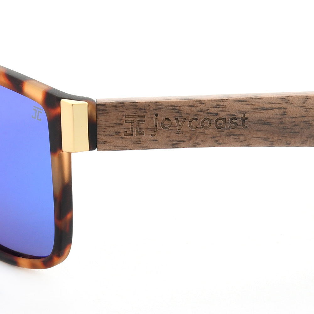 Sunglasses with tortoiseshell frame, gold-tone hinge, and wood temple