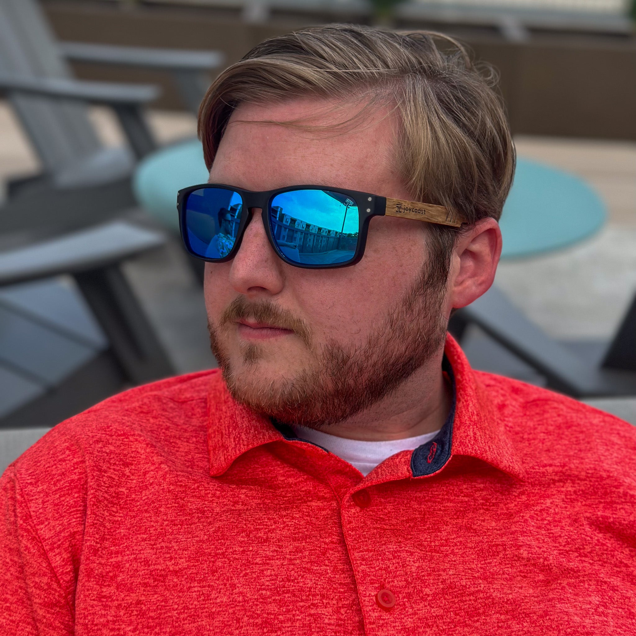 Sporty sunglasses with black frame, wood temples, and blue mirrored lenses