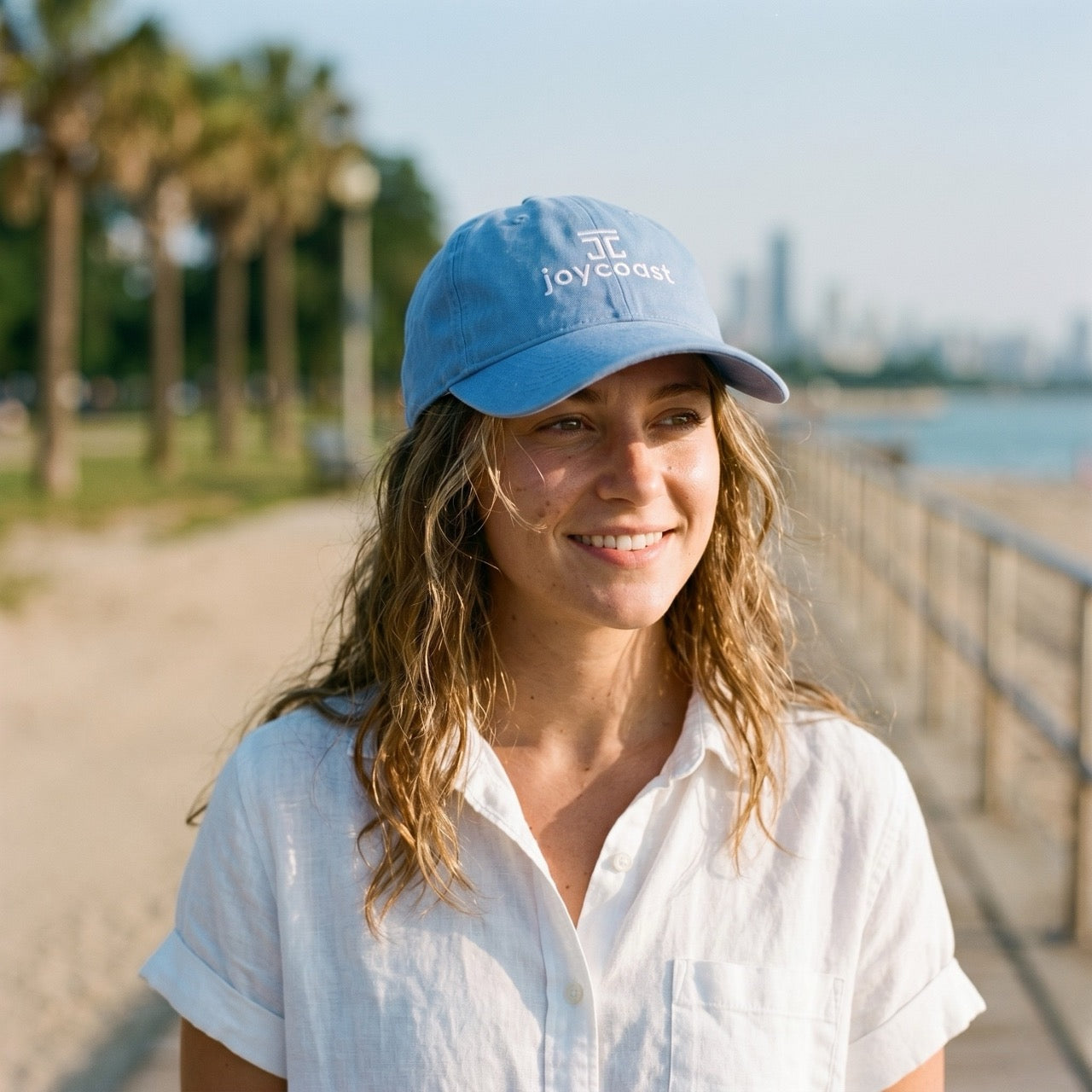 Sky blue cap with Joycoast front logo, worn