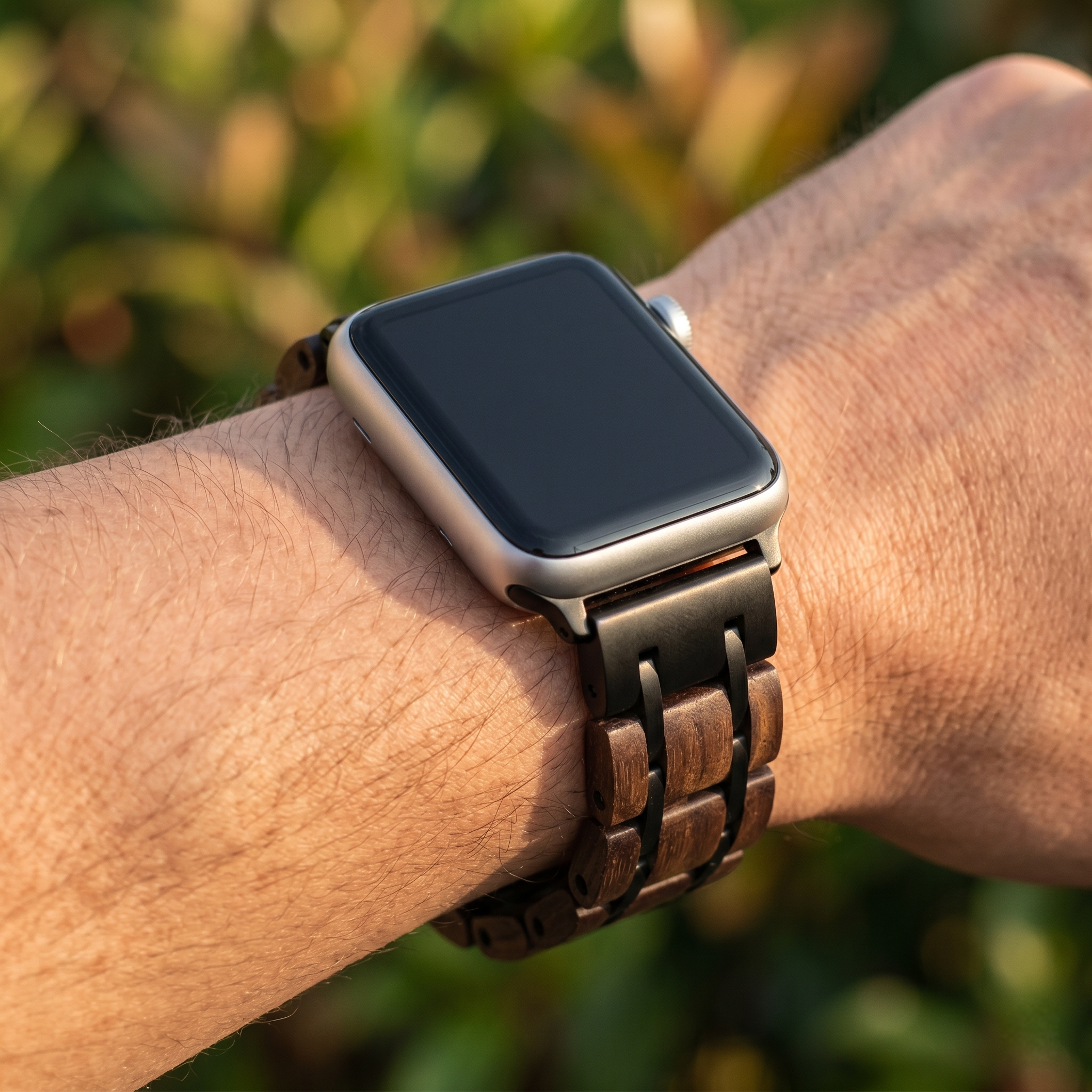A person wearing an Apple Watch with a stylish wooden band, showcasing a blend of technology and natural materials.