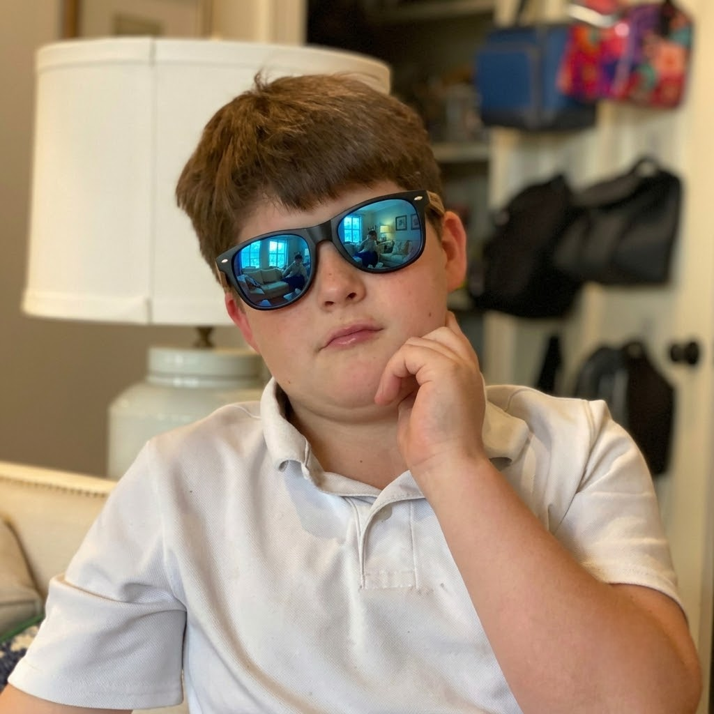 Kids wooden sunglasses on a child, blue mirrored lenses and black frame with wood arms