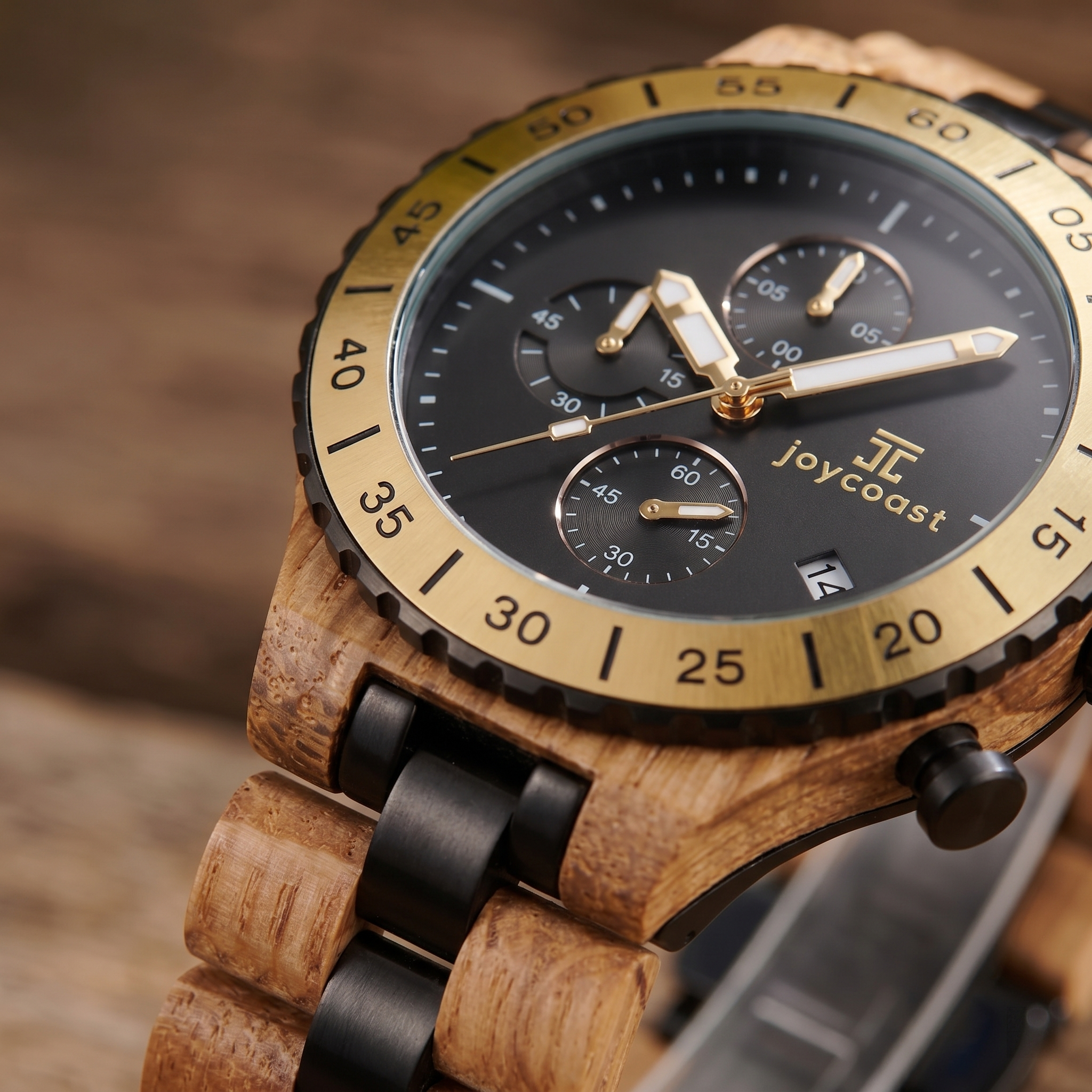 Zebrawood chronograph watch close-up with black bezel and wood strap