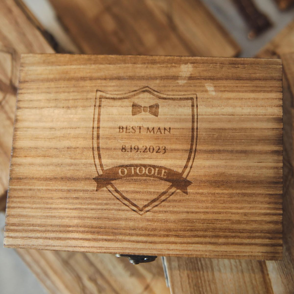 Engraved wooden gift box lid with ribbon badge and date text