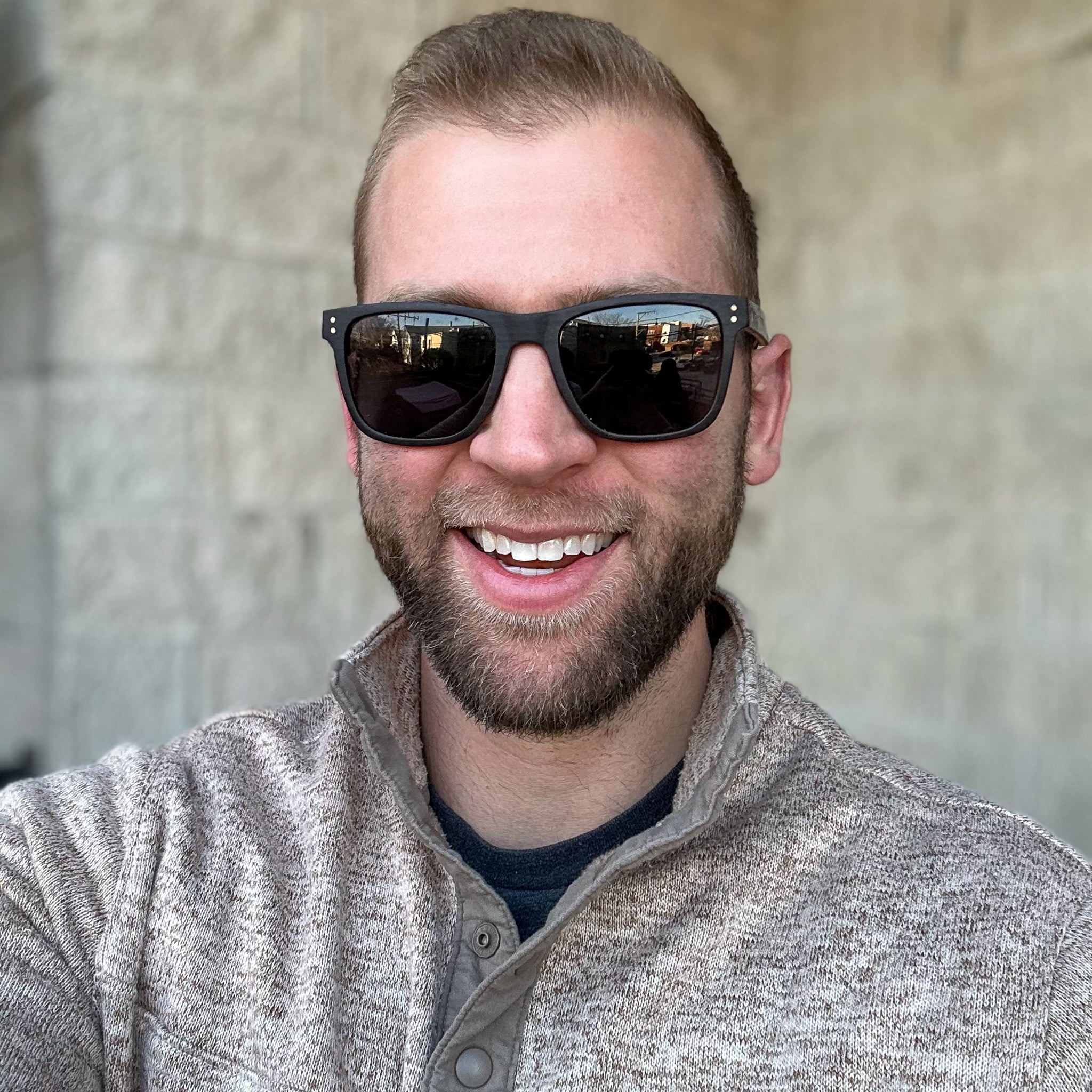 Wood sunglasses with dark lenses, square frames, and small logo on temple