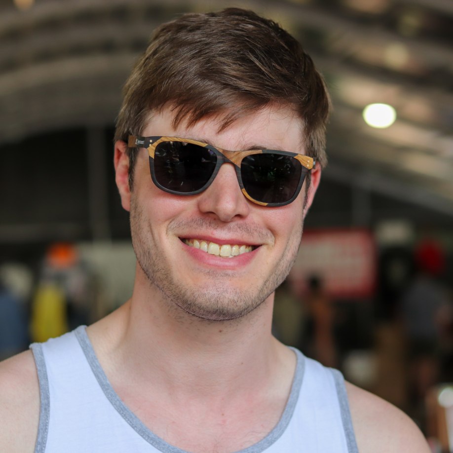 Sunglasses with dark lenses and zebrawood temples worn by man